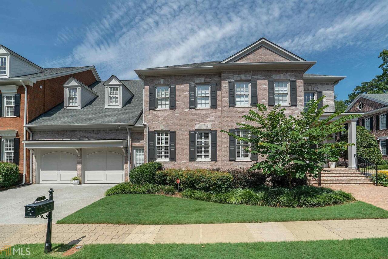 Nestled in a small, exclusive gated community clustered around a private park, this stunning (Luxury Built by John Weiland) end-unit townhome has all the expansive, private space of a single-family residence, plus an exterior that is maintained by an attentive HOA. Be charmed by a beautiful two-story foyer and formal living and dining room. The gourmet kitchen is beautifully appointed with a large center island, and overlooks a breathtaking fireside family room that is drenched in sunlight.  Retreat to your beautiful main level master suite and relax in a master bath with hand-crafted cabinetry and oversized frameless shower. The large covered deck has been screened for comfort and enjoyment. Upstairs is a private oversized media room with surround sound, a loft and three large secondary bedrooms with renovated baths. Downstairs, the finished terrace level can be used as a rec room or a fitness center, complete with a fabulous indoor endless pool that can double as a hot tub in its own tiled room--you may never need to go to a gym again! Rounding out the terrace level is an additional bedroom or office, as well as a large bath with double sinks and a steam shower. Updates are abundant with new roof, new windows (27), new garage doors, and much more. The Enclave is perfectly located to take advantage of the new Sandy Springs City Center and easy access to major Buckhead, Perimeter Center and Atlanta employment centers, as well as being only moments from Northside/St. Josephs/Children's Healthcare hospital complex. Classic living awaits you here!