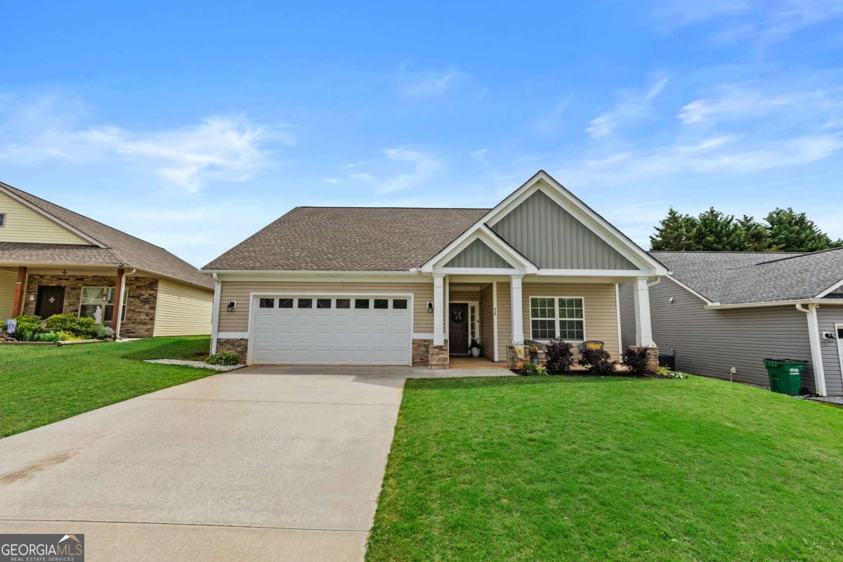 Welcome to this delightful single-story home, perfect for starter home, or those seeking to downsize in peaceful, serene location. This adorable home is designed with comfort and relaxation in mind. Roughly 24 minutes north of Gainesville, Ga. 10 minutes from shops and dining. The heart of the home is a bright, open-concept living area that seamlessly connects the living room, dining space, and kitchen, making it ideal for entertaining guests or enjoying family time. The kitchen boasts modern appliances, ample counter space. Step outback discover low maintenance landscaped yard, fenced in. Perfect for outdoor gatherings or quiet evenings under the stars. With its convenient single-story layout, this home offers ease of access and a welcoming atmosphere, making it a perfect place to create lasting memories.