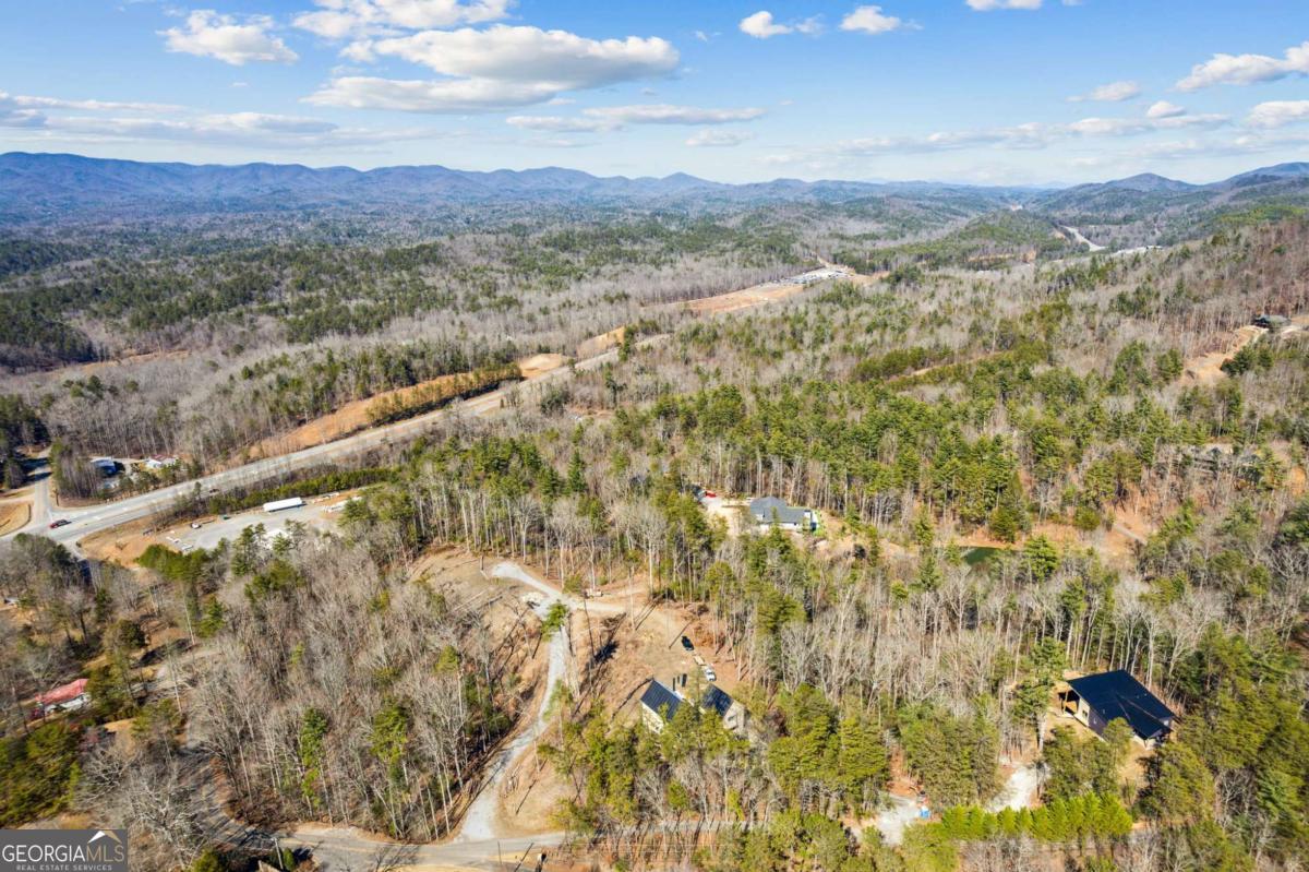 Build your dream home on this perfectly situated 1.82 Acre Lot, nestled in the heart of the North Georgia Mountains! This nearly 2 Acre property offers the ideal blend of privacy, convenience, & natural beauty, making it the perfect spot for your mountain retreat. Location, Location, Location ~ With easy access to both Ellijay & Blue Ridge & a short distance to one of North Georgia's newest fine dining restaurants, The Falls of Blue Ridge, this property offers luxury and convenience for both full-time & part-time living! Step into the mountain lifestyle you've been dreaming of! Whether you're looking for a primary residence, a vacation getaway, or an investment property, this lot puts you right where you want to be. Explore endless hiking trails & waterfalls, cast a line in nearby rivers & lakes, or visit one of the local wineries & orchards ~ all of this at your fingertips! Don't miss your chance to own this exceptional piece of North Georgia! The time is now to secure your place in the mountains - your dream home begins here!