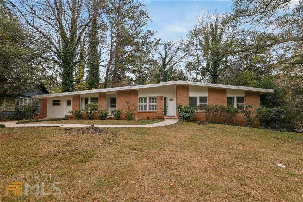 A True Mid-Century Contemporary architecture designed home near Emory University and the CDC. 4-sided brick, vaulted ceilings, exposed beams and an open floor concept. Features that belong in Dwell or Atomic Ranch magazines. Several built-in bookcases, walk-in pantry, double stainless sinks, double ovens, gas burning cooktop, Kenmore dishwasher and an eat-in kitchen. Tiled kitchen floor with hardwoods throughout the rest of the home. There is a large separate office as well as separate living and family rooms. Master bedroom has a deep walk-in and his/her closets. The grounds include three (3) separate outdoor areas including a large fenced-in backyard accessed off a wood deck, you have tons of private natural green space. New A/C and thermostat in 2021. Original sewer-line has been replaced A large bone-dry crawl space as bonus storage. Walk to parks, day schools and shops. Freshly painted front entrance.