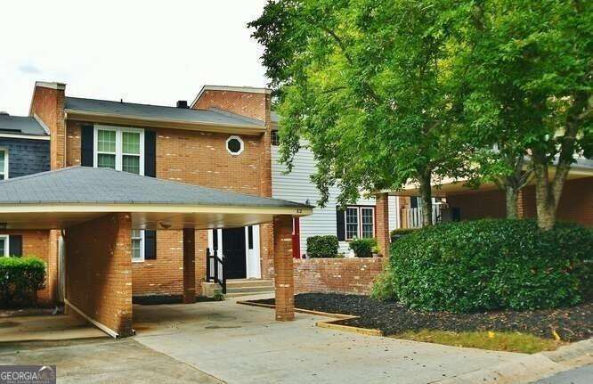 Amazing opportunity to own a townhome that has been totally renovated! Top to bottom, this home will wow you! Large living room with cozy fireplace and tons of windows, oversized deck, wet bar, fireplace, and 1/2 bath on the main level. 2 bedrooms 2 bath upstairs. One car carport and additional parking is available. The community is minutes from Lake Lanier and includes a clubhouse, dog park, walking trails, playground, pool, and tennis courts. Professionally Managed! All in a very popular school district and so close to Lake Lanier!
