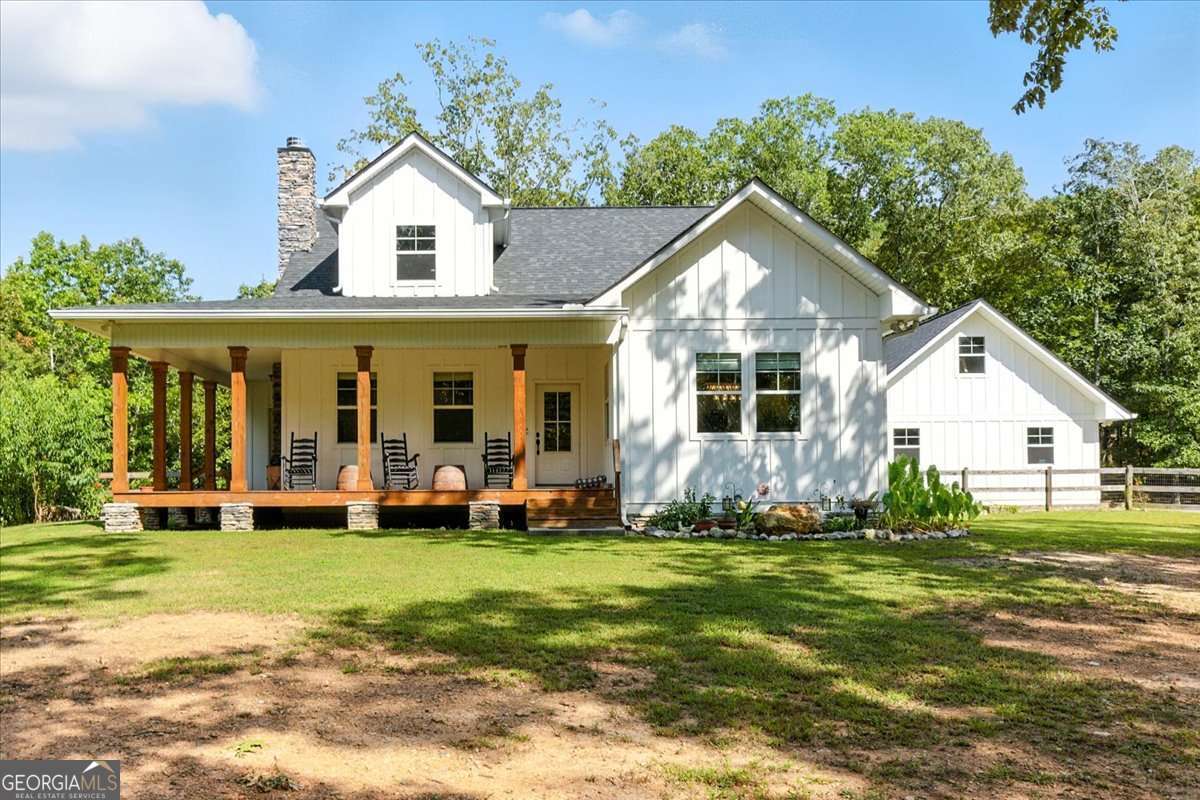 Tucked away on a serene 10-acre wooded lot in Bartow county, this custom-built modern farmhouse is a true private retreat. From the moment you arrive, the wraparound porch and classic farmhouse architecture invite you to slow down and savor the surroundings. Constructed in 2020 with 2x6 framing and Hardiplank siding, this home blends rustic charm with modern sophistication and energy efficiency. Step inside to soaring vaulted ceilings, an open-concept layout, and natural light pouring through the windows. The living room centers around a stone fireplace, while the loft above, with its built-in bookcases, makes the perfect reading nook or study space. The kitchen offers granite countertops, stainless steel appliances, and crisp white cabinetry, marrying farmhouse warmth with modern style. The primary suite is thoughtfully placed on the main floor, providing ease, privacy, and comfort - a standout feature for today's buyers. Two additional bedrooms and bathrooms complete the home. The partially finished basement adds exciting possibilities, with 2 oversized rooms plus a garage space with a boat door - ideal for hobbies, storage, or finishing into a spacious media room. Outdoor living is equally special, with a screened porch, fire pit area, fenced yard, and a custom chicken coop ready for your homestead dreams. The grounds also feature fruit trees and bushes, including blueberry, apple, pear, nectarine, and apricot - perfect for enjoying fresh harvests right at home. The detached 2-car garage is sheetrocked, features 220V power, and offers additional attic storage above. The 24x26 workshop with spray foam insulation, power and a stubbed bathroom expands your possibilities - perfect for projects, hobbies, or extra storage. Surrounded by trees, this property offers peace and privacy, yet is only 1.5 miles from the world-class amenities of Barnsley Resort - including fine dining, golf, spa, and outdoor activities. This property isn't just a home, it's a lifestyle.