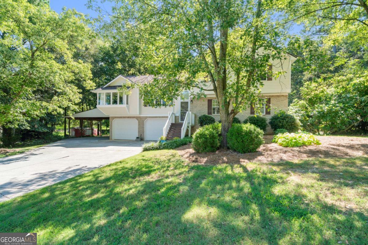 Nestled on a spacious 0.60-acre lot in Calhoun, this tri-level residence at 193 Farmington Drive offers both comfort and versatility, with no homeowners association restrictions. With four bedrooms and three bathrooms spread across 2306 square feet, this home provides ample space for varied living arrangements. The property is graced by mature hardwoods and vibrant perennials, creating a serene and inviting exterior that truly comes alive during the summer months. Upon entering, guests will discover a thoughtfully designed layout that balances shared living areas with private retreats. The main level hosts a welcoming living space, ideal for gatherings and relaxation. Adjacent to this, the dining area, featuring a bay window, offers a pleasant setting for meals, allowing natural light to stream in and views of the surrounding greenery to be enjoyed. The kitchen, updated with new countertops in 2024, is equipped to handle culinary endeavors with ease. Its functional design ensures a smooth experience for those who enjoy cooking and entertaining. The upper level of the home is dedicated to three bedrooms and two bathrooms, including the main primary suite. This expansive suite offers a private sanctuary with its custom-built bed frame and integrated cabinetry, which will remain with the home. The en-suite bathroom provides a separate tub and shower. A second bedroom and bathroom on this level offer additional comfortable accommodations, perfect for guests or a home office. The lower level introduces a unique and highly functional space. It features a second primary bedroom with an accessible bathroom, designed for ease of use. This level also includes a convenient kitchenette, providing independence and privacy for extended guests or a separate living area. A bonus room on this level offers flexible space that can be adapted to various needs, from a recreational area to a dedicated hobby room. For added convenience, an electric stair lift from the garage provides effortless access to the main level, enhancing the home's accessibility. Outdoors, the property continues to impress with its fenced backyard, providing a secure and private environment. This area is a true highlight during the summer, offering ample space for outdoor activities. A firepit creates a perfect spot for evening relaxation and marshmallow roasting under the stars, while a dedicated garden area invites green thumbs to cultivate their favorite plants. The home is also wired for a Goal Zero Yeti backup power source, offering peace of mind during unforeseen outages. This Calhoun residence provides a blend of comfort, adaptability, and thoughtful features, making it an appealing option for those seeking a well-appointed property in a desirable location without the constraints of an HOA. The attention to detail, from the updated kitchen to the accessible lower level and robust outdoor amenities, ensures a living experience that is both enjoyable and practical. To learn more about this exceptional property and to arrange a private viewing, please contact Jenny Smith & Associates.