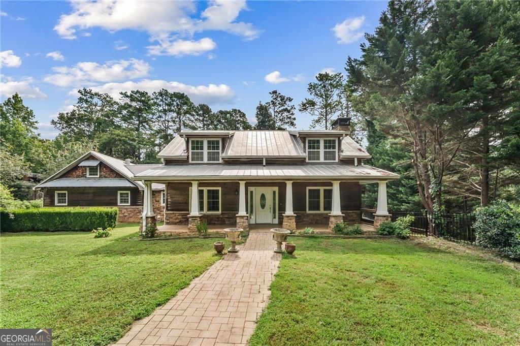 Private, fully fenced 1-acre retreat on 3 parcels - finished basement, outdoor retreat & endless potential in Mableton. A one-of-a-kind 3-bedroom, 3.5 bath home on three combined parcels totaling over an acre, just off Nickajack Road. Nestled on a private lot with a long, hidden driveway offering plenty of parking, this home offers the perfect blend of space, privacy, and freedom-with NO HOA restrictions. Bring your RV, boat, trucks, or toys-there's room for it all! Whether you love to entertain, garden or want space for a home-based business, this home delivers the flexibility to live, host, and expand as you please. Step inside to find refinished original hardwood floors and custom details throughout. The sunken living room with a fireplace sets a cozy yet elevated tone, while the chef's kitchen features high end cabinetry, stainless steel appliances, gas stove with convection oven, built-in air fryer, and plenty of space. The main-level primary suite is a cozy sanctuary with a dual-sink vanity, tiled shower, and a walk-in custom closet. Upstairs, two spacious bedrooms each include walk-in closets, built-in desks, and reading nooks with hidden storage. This home features a fully finished 1,200 sq ft basement with its own full kitchen, a bathroom, and private covered stone patio & entrance. It's ideal for entertaining, gym, studio, home office, family room. The home also offers outdoor living at its best, offering multiple areas to relax, entertain, and enjoy nature in a quiet, tranquil setting. A large rocking chair front porch, the covered lower stone patio or partially covered, large rear patio provide perfect areas for outdoor entertaining or quiet evenings. With many custom details, including a large granite table, fire pit and grill area and a zoned indoor/outdoor speaker system, the opportunities are endless. A large gazebo equipped with ceiling fans and speakers is centered in the expansive garden, ideal for entertaining or special celebrations. A tool/work building next to the large, covered RV parking area offers the perfect place for hobbies, or projects. The yard provides plenty of room to add a pool, or vegetable garden, making this property as functional as it is beautiful. Additional highlights include a durable metal roof built to last, three HVAC units that provide zoned comfort across every level of the home, and separate entrances for both the main level and the basement, offering flexibility. Just minutes from several coveted area private schools, Heritage Park, the Silver Comet Trail, and Mable House Amphitheater, this property offers tranquility without sacrificing convenience to the City, Airport and the many sports venues. This is more than a home-it's a lifestyle. It is a rare opportunity to own a truly unique Mableton retreat with space to grow, entertain, and live freely. The possibilities are endless.