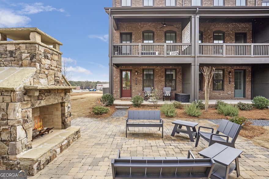Welcome to Halcyon, Alpharetta/South Forsyth's Premier Live-Work-Play Community!  Discover a new standard of living at Halcyon, where vibrant, walkable urban life meets convenience and tranquility. Nestled just off GA 400, this dynamic community offers a healthy lifestyle with easy access to Big Creek Greenway, a variety of restaurants, shops, Trader Joes, and much more. It's the perfect location to enjoy all the amenities of modern life, while being surrounded by nature.  This meticulously designed terrace-level, end-unit home strikes the perfect balance between modern elegance and functional living. The open-concept floor plan is flooded with natural light, creating a bright and inviting atmosphere throughout. The main level features a spacious dining room and a gourmet eat-in kitchen, complete with a gas cooktop, sleek hood vent, premium cabinetry, and stainless steel appliances. Overlooking the large living room, this kitchen is perfect for entertaining. Step outside to one of two covered outdoor living spaces and relax with beautiful courtyard views.  The private owner-suite is a true retreat, featuring a luxurious bath and offering ultimate comfort and privacy. With two additional bedrooms, each with its own en-suite bath, every member of the household will enjoy their own space and privacy. The home also boasts a two-car garage, ensuring both luxury and convenience.  Halcyon Garden community's centerpiece features a clubhouse with restrooms and kitchen, a refreshing swimming pool, and a beautifully manicured courtyard complete with an outdoor fireplace, ample seating, and lush green space ideal for relaxation or hosting gatherings with friends and family.  For outdoor enthusiasts, the home is perfectly situated along the Big Creek Greenway, granting direct access to over 26 miles of scenic trails. Enjoy the serenity of nature while being just minutes from the vibrant downtown Alpharetta.  Don't miss out on this rare opportunity to own a move-in-ready home in one of Alpharetta's most sought-after neighborhoods. Schedule your showing today and experience the best in modern living, convenience, and community!