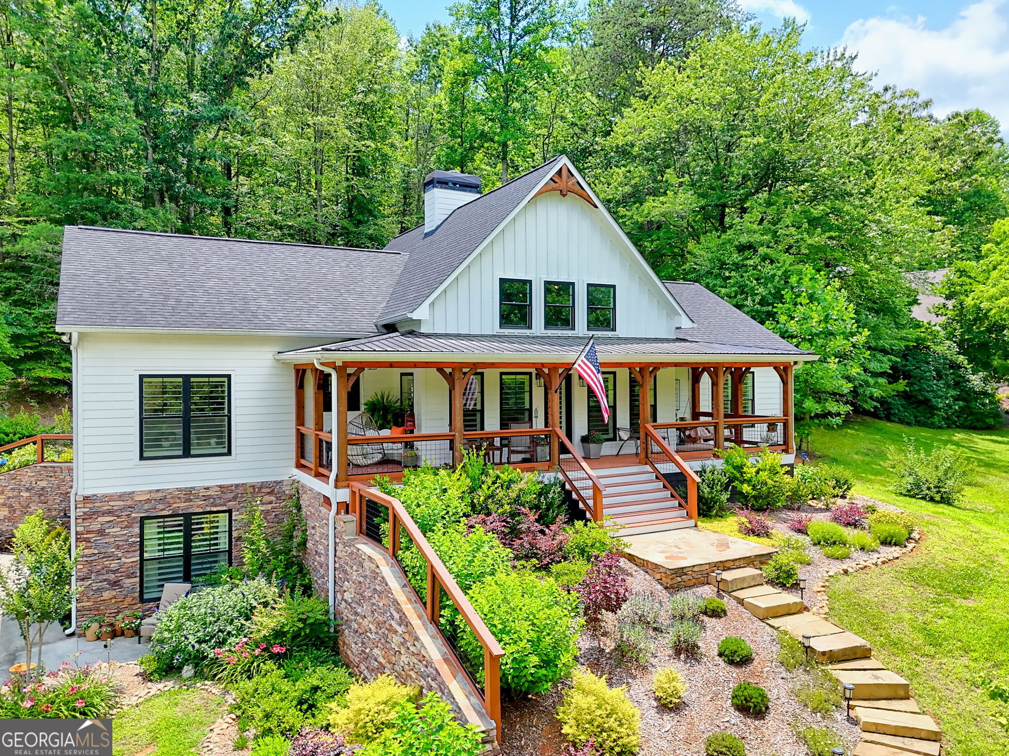 This amazing property is hitting the market for the first time ever. Built as a forever home, this home shows as a new construction home and property. 3.5 acres of level to gently sloping land that has been meticulously landscaped and planned for every idea or dream. A small orchard loaded with fruit flanks the property on the left as you approach the home along the black walnut tree lined road. As you turn into the drive, you will be welcomed by the detached garage ahead of you opposite the stone path to the house lined with a multitude of flowers and shrubs. Landscaping has been designed to have something in bloom all season adorns the rock basement walls. There are two ways to enter this home. Ground level entry brings you into the downstairs suite complete with full kitchen, bedroom, bath, and multiple flex and storage spaces. If you enter through the main entry you will be welcomed by a gorgeous rocking chair front porch where you can sit all year and enjoy valley and partial mountain views, along with the changing of the leaves on the giant maples in your own front yard. Through the entry awaits an open floor plan to the country kitchen with custom cabinetry and a large custom hardwood island. Large antique beams adorn the high callings in the living area and help to draw the eyes to the floor to ceiling fireplace stacked with stone facing the entry. The main level consists of the primary bed, bath, and walk in closet to the left of the kitchen with 2 other bedrooms and bathroom to the right of the living space. Bedrooms have walk in closets and plenty of space for relaxation. If you decide to dine outdoors for the evening, you will have no trouble with the ample space and inviting layout of the patio space out back. Hosting abundant space to grill or cook anything you want, the backyard chef will be in a dream space while the guests can relax on the patio or in the large Bullfrog spa as they take in the flowers and landscaping in their own private oasis. So much thought, planning, and love have gone into the design and functionality of this property to make it all one will ever need. Oh, did I mention the antique barn that is on the property and part of the original farm that use to be throughout the valley? Don't miss out. This kind of home is a rare find and will be the place for many memories to be made. Is this your dream?