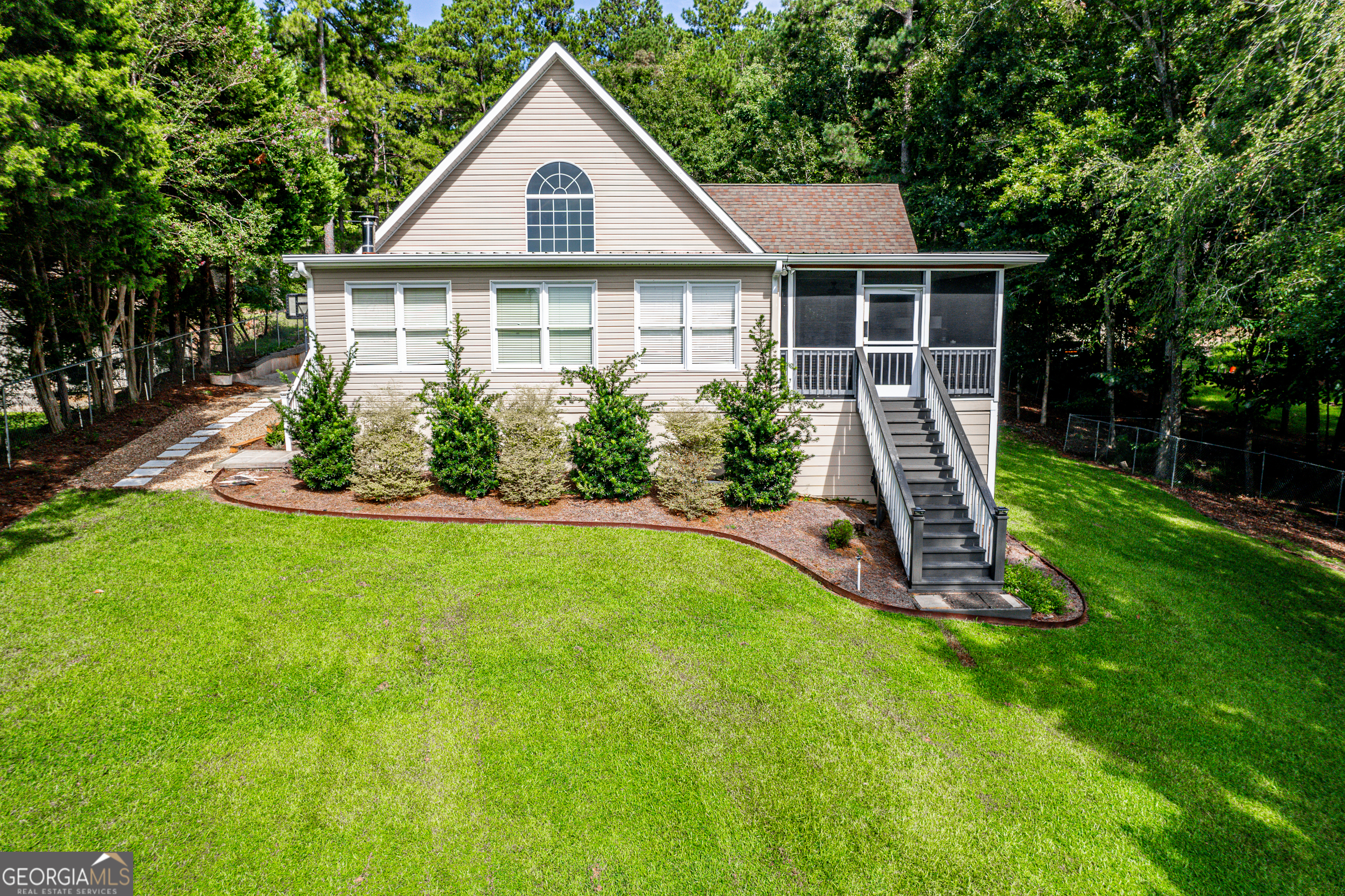 Welcome to Lake Sinclair living at its finest! This 4 bedroom, 3 bath lakefront home offers the perfect combination of comfort, fun, and lake lifestyle. Inside, you'll find a spacious floor plan with plenty of room for family and guests. The kitchen and living areas flow seamlessly together, making entertaining a breeze. The large garage has been converted into the ultimate game room and bar area, perfect for hosting friends after a day on the water. Step outside to your private max dock, where you can launch your boat, fish, or simply relax and take in the views. This property is designed for enjoying all that Lake Sinclair has to offer. Whether you're looking for a full-time residence or a weekend getaway, 105 Sands Drive is ready to be your lakefront retreat.
