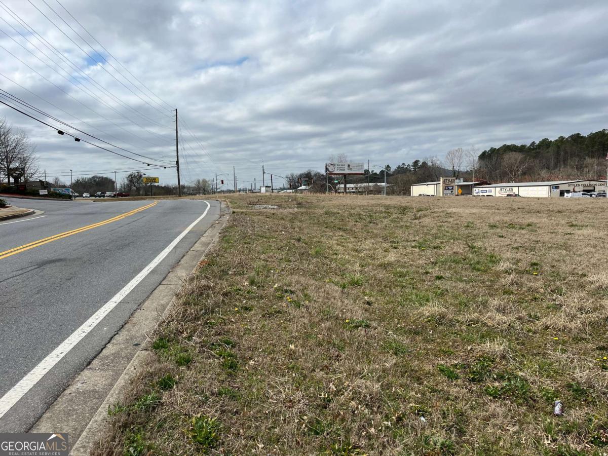 Commercial lot for sale on busy west side of Cartersville. Double road frontage on Hwy 113 and Old Mill Road. Zoned O-C in City of Cartersville, heavy morning traffic. Close to city schools. All utilities available.