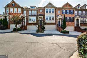 Discover spacious townhome living in the heart of Smyrna with this 4-bedroom, 2 full bath, 2 half bath residence offering 2,430 sq ft in the sought-after Westwood Terrace community. It's all about the location-just three houses to your right from the Silver Comet Trail, bringing outdoor recreation right to your doorstep. Shopping is only a block away, and major highways including I-285/75/20 are minutes from home, making commuting effortless. A striking two-story foyer with a chandelier welcomes you into the home. The main floor is designed for both everyday living and entertaining, featuring hardwood floors, a cozy fireplace, stainless steel appliances, and updated modern light fixtures that elevate the open-concept kitchen, dining, and living areas. Step outside to the private porch off the living room, perfect for relaxing or entertaining outdoors. A convenient half bath completes this level. Upstairs, the oversized primary suite offers a true retreat with a spa-inspired bath featuring a double vanity, separate shower, soaking tub, and walk-in closet. Two additional bedrooms provide ample closet space and share a full bath, offering plenty of room for family or guests. The finished basement includes a flexible bedroom perfect for a guest suite, home office, or additional living space, along with a half bath, laundry room, and two-car garage with ample storage, adding convenience and functionality to everyday living. Step outside to your private backyard patio, perfect for relaxation. Enjoy the community pool right outside your front door, providing a true resort-style experience for relaxation, socializing, or cooling off on warm Georgia days. Perfectly situated, this home is just minutes from Vinings, The Battery, Truist Park, Cumberland, and Cobb Galleria, combining suburban tranquility with urban convenience. With the Silver Comet Trail right next door, shopping a block away, and easy access to I-285, I-75, and I-20, this location truly offers the ideal mix of lifestyle and practicality. Don't miss the opportunity to own a beautifully maintained home in one of Smyrna's most sought-after communities, offering comfort, style, and a prime location for modern living.