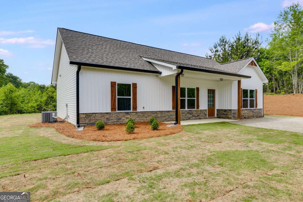 GORGEOUS NEW RANCH ON 3 PRIVATE ACRES - NO HOA, NO SUBDIVISION - JUST COUNTRY LIVING AT ITS BEST!!! Limited-time offer: Get a FREE appraisal and $3,000 in incentives when you work with our preferred lender! (Ask listing agent for terms.) Escape the hustle and bustle and come home to peace and privacy! This stepless ranch is under construction on a picturesque 3.046-acre lot in the quiet countryside north of Buchanan, just off Hwy 27 heading toward Cedartown. You'll love the easy access to town, with the comfort of your own spacious retreat. Step inside to soaring vaulted ceilings and an open-concept layout that feels light, bright, and welcoming. With 3 bedrooms and 2 full baths, there's plenty of room to spread out-and yes, there's still time to choose your finishes and make it truly YOURS! The kitchen is the heart of the home, boasting granite countertops, a counter-height bar, and a stainless steel appliance package (electric range, microwave, and dishwasher included!). The private owner's suite is your getaway, complete with a large walk-in closet, double vanities, framed mirrors, granite countertops, and a sleek stand-up shower. Two generously sized secondary bedrooms share a stylish full bath with granite vanity and tub/shower combo. You'll also enjoy ceiling fans in the living room and owner's suite for added comfort. Outside, the home will feature easy-care vinyl siding with a stone water table for extra curb appeal. Don't miss this rare opportunity to build your dream home in the country-with room to breathe and no pesky HOA! ***Photos are representative and not of the actual home.***Construction is in the earliest stages-contact the listing agent today!***