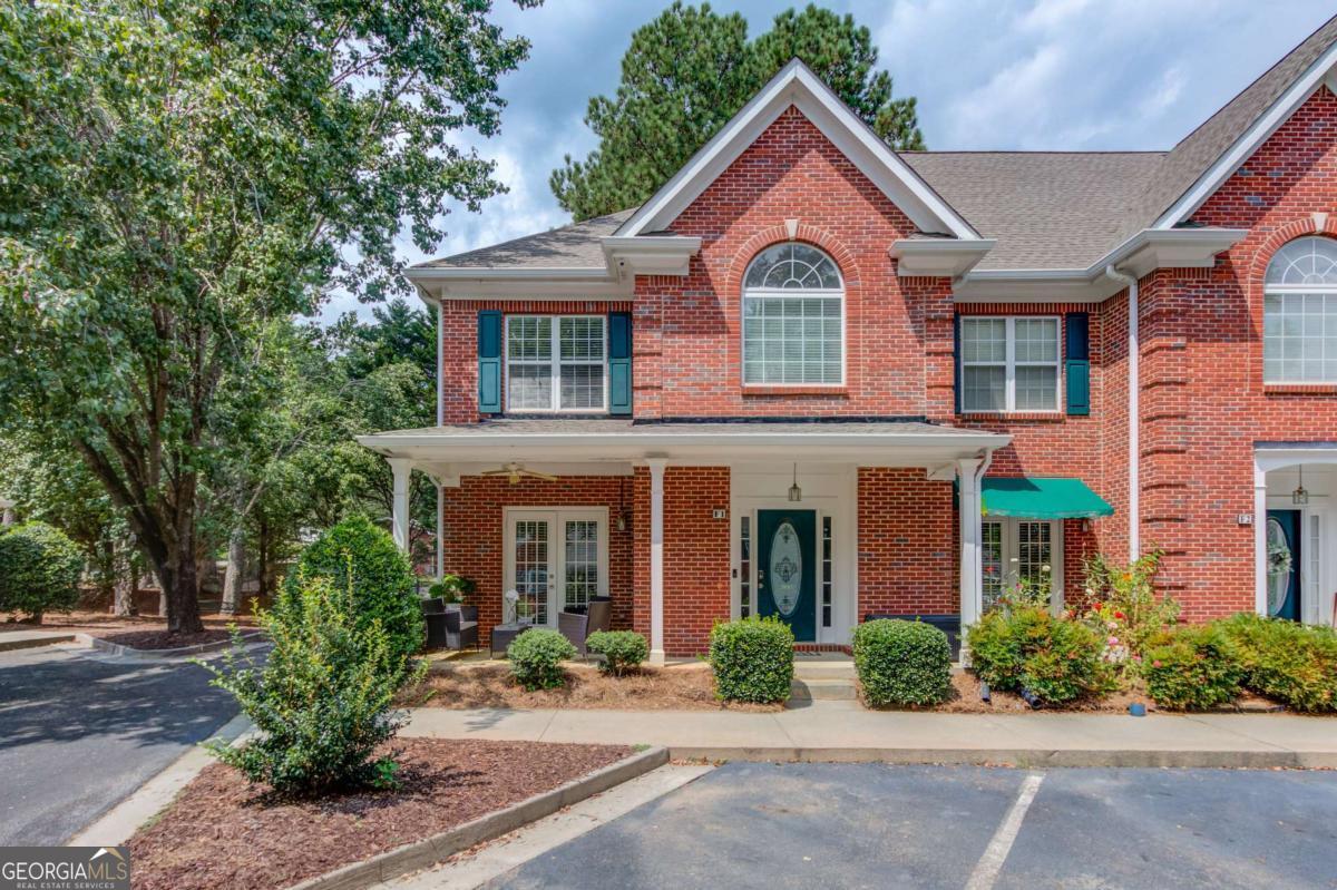 Located in the highly desirable Buford City School District and just steps from Lake Lanier, this beautifully updated 2-bedroom, 2.5-bathroom home offers the perfect blend of modern comfort and resort-style living. From the moment you step inside, you're welcomed by an open and inviting layout. The main level features a granite kitchen that flows seamlessly into the dining area and great room. Double French doors lead to a covered front porch, while the great room centers around a cozy gas fireplace and opens to the back patio and lawn-ideal for relaxing or entertaining. Upstairs, two spacious owner's suites each with private baths provide the ultimate privacy-perfect for roommates, guests, or family. The main level is enhanced with durable LVP flooring, while recent updates include a newer HVAC system, roof, and water heater for peace of mind. This home includes two assigned parking spaces and exceptional community amenities: a resort-style pool, new dock, flowering courtyards, and meticulously maintained landscaping. HOA dues cover water, trash, termite, landscaping and exterior maintenance, making for low-maintenance living. Enjoy the convenience of walking to the Buford City boat launch and being minutes from Margaritaville, Lake Lanier Islands, and downtown Buford's shopping, dining, and entertainment. This rare opportunity combines lakeside living, modern updates, and a top-rated school district in one of Buford's most sought-after communities.
