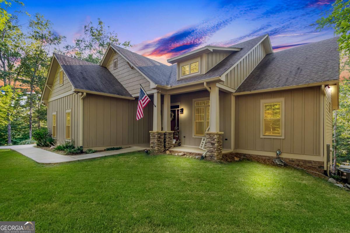 Experience elevated mountain living just outside Blue Ridge in this custom 5BR/3BA home. Thoughtfully designed with upscale finishes, the home features granite countertops, a walk-in pantry, and unique stonework in the bathrooms. The spacious master suite offers a custom walk-in closet and private access to the screened back deck-also accessible from the dining room and guest bedroom. Enjoy seamless indoor-outdoor living, plus modern comforts like smart home tech, fiber internet, a heated whirlpool tub, and a gas fireplace. The finished basement is perfect for entertaining with a bar, surround sound, built-in cabinetry and an additional laundry room. A wide driveway, 2-car garage, and two fully-wired sheds add convenience and flexibility. Located in Harbin Woods, a gated community with paved roads, walking trails, and a peaceful pond-just minutes from Lake Nottely. This is mountain charm with a refined edge.