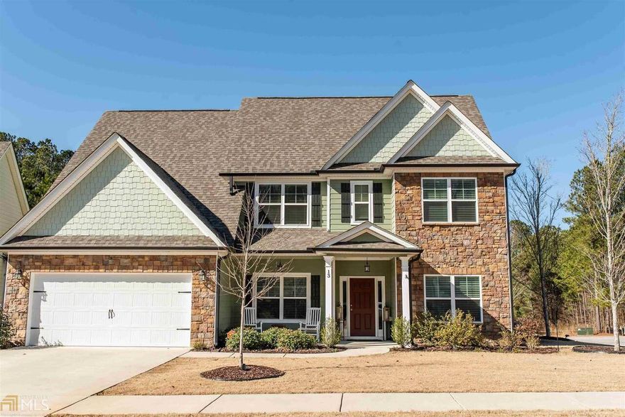 This beautiful like NEW Newnan craftsman home transitions both craftsman and modern elements creating an elegantly enduring design and flowing spaces great for entertaining.  Lovely hardwood floors lead to the formal dining room featuring craftsman wainscoting, coffered ceiling and transitional lighting. French doors lead to the cozy living room/office. Chef's island kitchen boasts craftsman style cabinets, granite counter tops, custom backsplash, stainless steel appliances, two pantries, an eat-in kitchen and breakfast nook. Enjoy your morning coffee next to the stacked stone fireplace in your vaulted family room open to the eat-in kitchen. Glass doors lead from the kitchen's breakfast nook to large upgraded covered porch, perfect for entertaining guests at a summer cookout. Laundry room with extra storage for pantry is off kitchen with easy access. Owners suite on the main level boasts rustic wood feature wall and spacious walk-in closet. There's plenty of space in the owner's suite bath with double vanity, soaking tub and separate tiled five foot shower, both with feature strip. Elegant stairs featuring iron pickets in the railings lead up to three additional bedrooms and two full baths. Craftsman doors and insulated windows throughout. Quiet neighborhood just minutes from Piedmont Newnan hospital, shopping and restaurants at Ashley Park. This home sits on a sizable landscaped corner lot great for kids and pets. Neighborhood amenities include lake, pool, clubhouse and playground. Seneca Park at the Parks of Olmsted.