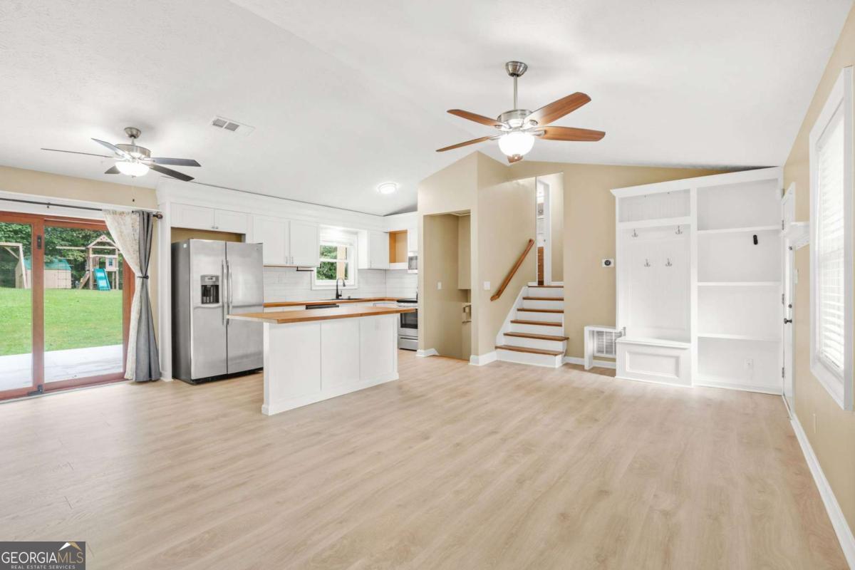 Welcome to this charming 4-bedroom, 2-bathroom home nestled on a spacious 0.5-acre lot in a quiet, established neighborhood with no HOA restrictions. Perfectly located within walking distance to award-winning Brookwood High School, and minutes away from Scenic Hwy, this move-in-ready home combines modern upgrades with timeless charm. Inside, you'll find a bright and open floor plan featuring luxury vinyl plank flooring, fresh paint, and updated lighting throughout. The heart of the home is the chef-inspired kitchen with butcher-block countertops, stainless steel appliances, custom cabinetry, and a stylish tile backsplash. The spacious living room and dining area offer plenty of room to gather and entertain. The home boasts two primary suites, including one on the lower level-ideal for guests, in-laws, or multi-generational living. All bathrooms have been tastefully updated with contemporary fixtures, vanities, and tile work. Step outside to enjoy the expansive backyard, perfect for outdoor entertaining, gardening, or simply relaxing in your private oasis. With an extended driveway, and plenty of yard space, you'll have room for all your needs-plus, no HOA means no restrictions on RVs, boats, or additions. Don't miss your chance to own this beautiful home in one of the most desirable school districts in the area. Schedule your showing today!