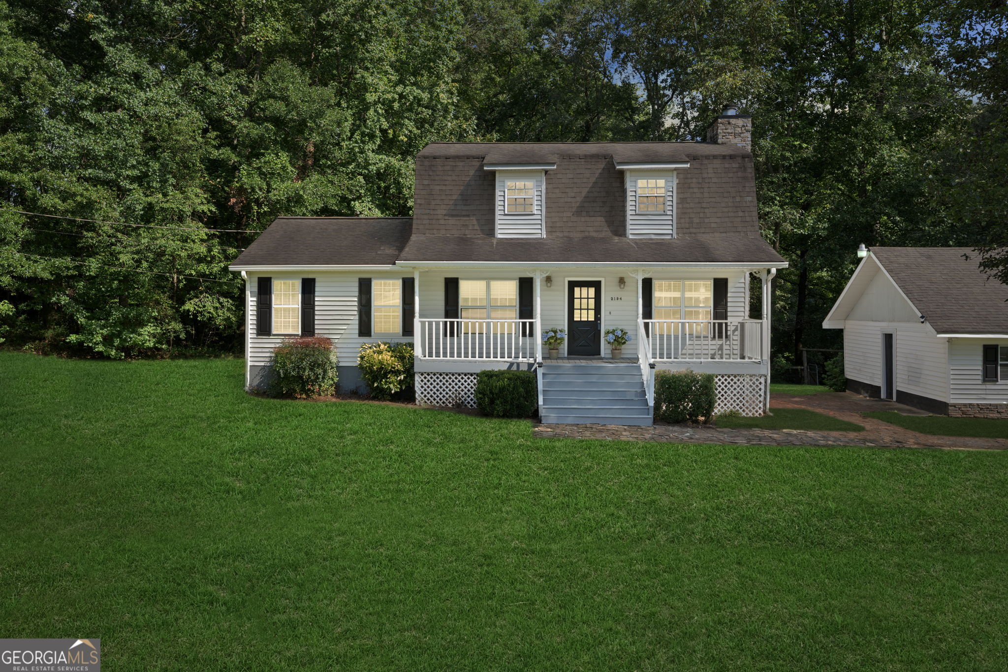 NO HOA!!!! Discover the perfect blend of country charm and modern comfort in this beautifully updated Cape Cod-style home. Nestled on a serene property with its own private pond, this home offers a peaceful rural feel while being just minutes from city conveniences. The inviting main-level primary suite features a garden tub, while recent renovations bring fresh appeal with new flooring, paint, and kitchen countertops. Enjoy morning coffee on the front rocking chair porch or unwind in the Jacuzzi hot tub on the screened porch overlooking the tranquil surroundings. A separate barn provides space for hobbies or storage, and the exterior double garage with an attached 3-car carport ensures plenty of parking. Whether you dream of gardening, fishing in your own pond, or simply soaking up the quiet, this property delivers the best of country living without sacrificing convenience.