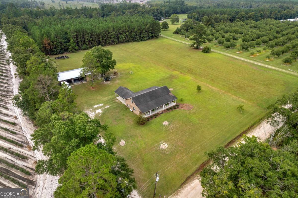 Brick farmhouse beauty on 4.71 acres and 3000 square feet! Country roads can take you home to the place you belong. Imagine evenings spent on your back porch, swinging on the porch bed swing overlooking your beautiful land. As you walk into this home from the oversized front porch, the front door opens to a large living room with tray ceilings. The dining and kitchen flow effortlessly from the living area. The kitchen is well equipped with beautiful granite countertops, custom cabinetry, pantry, stainless steel appliances. The primary suite is spacious and takes up the entire left side of the home. Large bedroom, walk in closet, primary bathroom with soaking tub, oversized shower double vanities and separate water closet. There is a flex room near the primary suite that is currently being used as a craft room but could also be a home office/study. The laundry room is near the primary and has an exterior entrance. Downstairs you will also find 2 guest rooms that share a bathroom that has a shower/tub combo. Upstairs is a large oversized bonus room that is currently being used as a 4th bedroom. The outdoors are expansive with a shop that has storage, parking and a plug in for a RV. This home has well and septic. Don't miss out on this country dream!