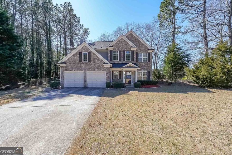 Stunning Brick Home in West Cobb - A Perfect Blend of Comfort and Style  Welcome to this charming brick home in the highly sought-after West Cobb area! As you step into the grand two-story foyer, you'll immediately notice the brand-new luxury vinyl plank flooring throughout the main level. The spacious layout includes a formal dining room and living room, ideal for hosting gatherings and creating lasting memories.  The chef-inspired kitchen features crisp white cabinets, elegant granite countertops, and stainless steel appliances. The kitchen flows seamlessly into the inviting family room, which boasts a fireplace and an abundance of natural light, creating a warm and welcoming atmosphere.  Upstairs, the generous owner's suite provides a peaceful retreat with double vanities, his and her closets, a separate shower, and a soaking tub, perfect for relaxation. The home also offers generously sized secondary bedrooms, ensuring comfort for all.  Step outside to your private, fenced backyard, surrounded by lush trees. It's the perfect space for enjoying a morning cup of coffee or tea, or unwinding on the relaxing patio. The fire pit is ready for family s'mores nights under the stars!  The Macland Park Community provides excellent amenities, including a clubhouse, pool, playground, tennis courts, and a picnic area, offering a lifestyle of convenience and leisure. Ideally located near grocery stores, dining options, and walking trails, this home is also situated within an excellent school district, providing the best educational opportunities for your family. New upstairs A/C unit and water heater.  Don't miss the chance to call this lovely property home!