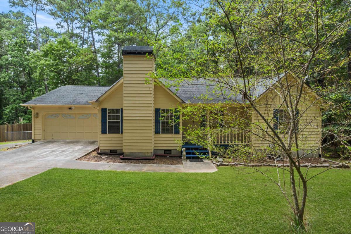 CHARMING 3-BED/2-BATH UPDATED RANCH ON ONE ACRE IN LOGANVILLE - NO HOA! This home seamlessly blends blends comfort and character, featuring a beautifully styled kitchen with warm navy blue cabinets and gold accents. The open-concept dining and kitchen area flows seamlessly into a cozy living room with a fireplace, perfect for relaxing or entertaining. Enjoy the outdoors with a fenced backyard, mature trees, and a spacious back deck with stairs leading to the yard. A welcoming front porch offers the perfect spot for rocking chairs and quiet mornings. Thoughtfully designed and nestled in a peaceful setting, this home is filled with charm and ready to welcome you home.