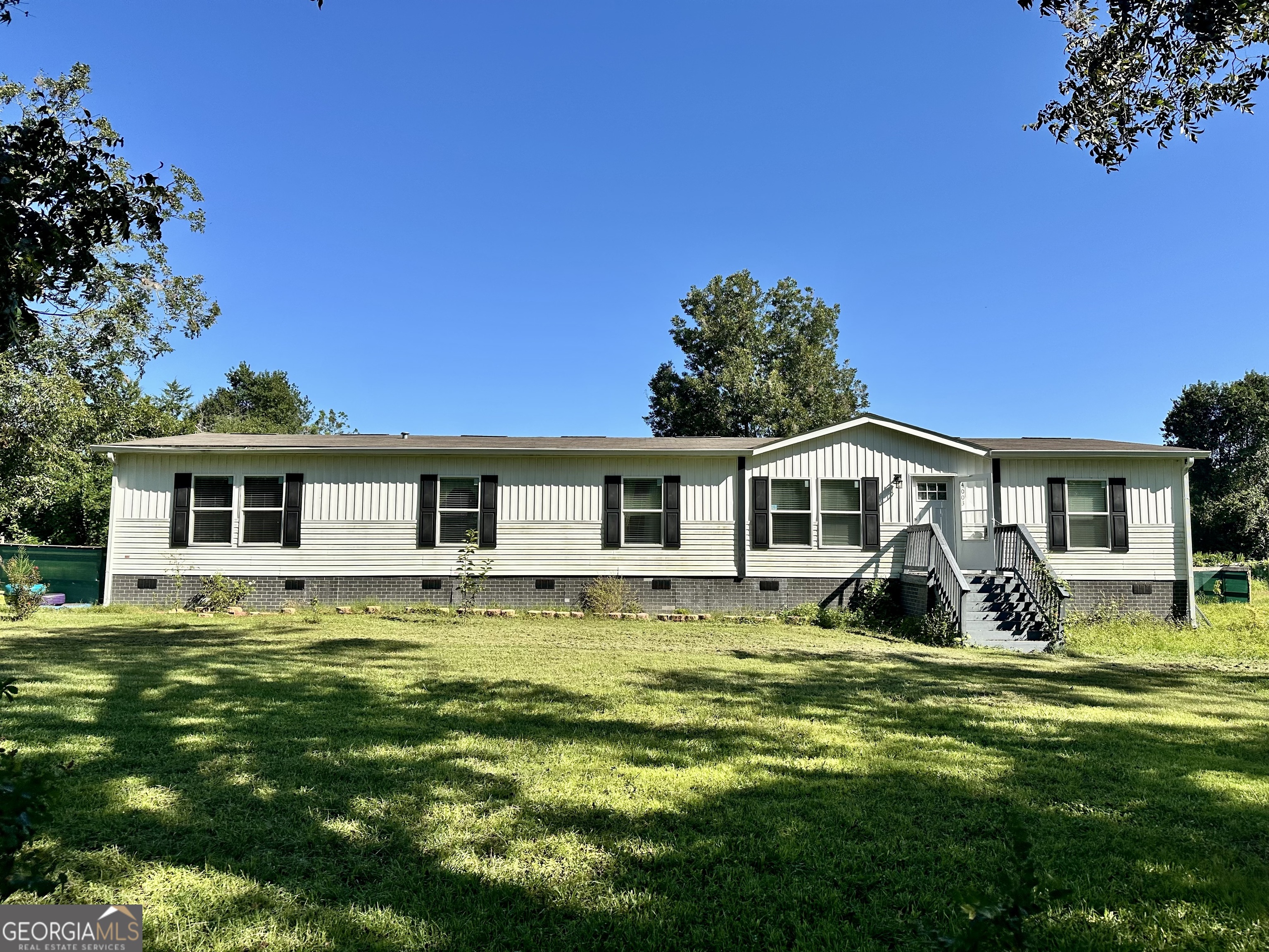 Welcome to peaceful living in Blackshear! This 2020 Clayton home sits on just under an acre, offering space, comfort, and modern convenience. With 4 bedrooms and 2 baths, the split floorplan is designed for both privacy and connection. Step inside and envision gatherings in the spacious open kitchen, dining, and living area-plenty of room to cook, eat, and enjoy time together. The primary suite is a retreat of its own, complete with a large walk-in closet and ensuite bath with double vanity. On the opposite side of the living room, three additional bedrooms each feature their own walk-in closet, making sure everyone has space to stay organized. A hallway bath adds convenience for family or guests. The large laundry room leads out to the screened-in back porch, a perfect spot to relax with coffee in the mornings or unwind in the evenings. Beyond the porch, the fenced backyard with privacy screening and built-in shelving is ready for pets, play, and outdoor living. Set on 0.92 acres, this property gives you the freedom of extra space while still offering the warmth of home. Whether you're hosting friends, enjoying quiet afternoons, or watching kids and pets play safely in the yard, this home is ready to fit your lifestyle.