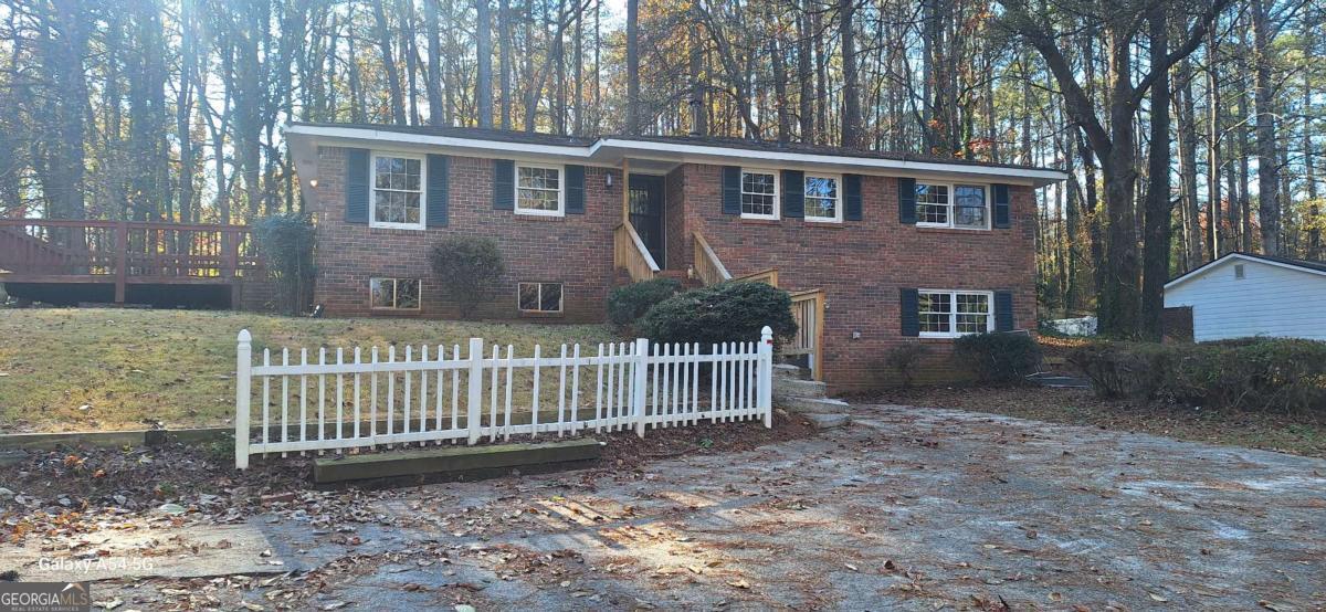 Lovely three, possibly four-bedroom home, four-sided brick located on 2.4 acres in desirable East Cobb. Plenty of room to add on. NO HOA! Very Clean, ranch home with a basement. The main floor offers original hardwood floors, a galley-style kitchen with a bar and vinyl floors, a Dining room den combo, one full bath, three bedrooms, and one-half bath. The basement features a laundry area, a half-bath, a storage area, and a large den with an exterior door entry, with two additional rooms that could be made into another bedroom. Private backyard, plenty of room to expand.