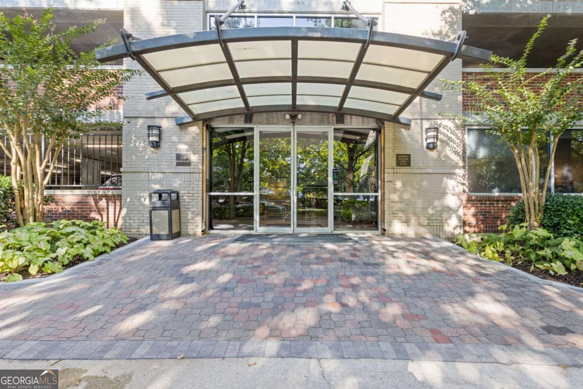 Welcome to Unit 1401 Mathieson Exchange Lofts! This incredible double unit affords you the lifestyle you've been craving - you literally don't need a car (but if you want one, there are two amazing covered deeded parking spots). Located in the heart of trendy Buckhead, the Mathieson Exchange Lofts (MEL) is a premier, full service condominium building with a 24-hour concierge staff. MEL is within walking distance to numerous restaurants, The Buckhead theater, Buckhead Village and many fashionable shops. The building is a 16-story residential loft high-rise and located on Mathieson Drive near its intersection with Peachtree Road - right across from Peachtree Road UMC. These lofts are the epitome of good design. The walls themselves are art, displaying meticulous brickwork, curving shapes, and arching windows. The amenities are stellar including the rooftop terrace with club room, pool table, etc...additional amenities include a pool with grilling area, newly revamped gym, and a dog walk. This unit (just one of 4 on the 14th floor), has one of the largest terraces with the most incredible panoramic views of Atlanta and beyond. With soaring ceilings and fabulous windows, the home is flooded with natural light. The kitchen was designed for a professional chef with high end appliances, double ovens and the most storage/cabinetry you have ever seen. There is a dedicated office with custom woodwork and exceptional storage as well as custom cabinetry and build outs in both of the en suite bedrooms. The primary bedroom is spacious and has yet another outdoor space. This home also has fresh paint, newer HVAC & water heater and a dedicated storage unit. Stop spending all of your time in a car, come and live the lifestyle you've been waiting for!