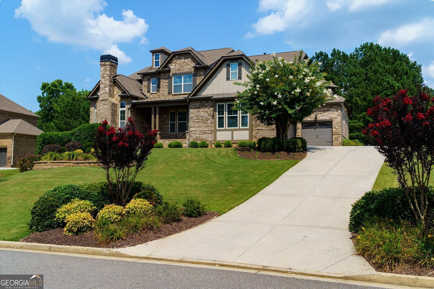 4-sided brick estate home featuring 6 bedrooms and 5.5 bathrooms on full, finished basement. The covered front porch welcomes you into the well lit spacious dining room with coffered ceiling and wainscoting, offering hardwood flooring situated across from the vaulted office with door featuring a stone fireplace. Two story foyer with wainscoting and a wrought iron spindled staircase. Spacious eat in kitchen with large sit at breakfast bar with granite countertops, Travertine tile backsplash, abundant dark stained cabinetry, stainless steel vent hood, pot filler, gas cooktop, electric oven, built-in microwave and dishwasher all open to the keeping room with stone fireplace and great room. Spacious walk-in pantry and mudroom station. Spacious bedroom on the main level with sitting room with built-in bookcase cabinetry and full bathroom. Butler's pantry with wine refrigerator. Large primary bedroom upstairs with trey ceiling with ceiling fan and sitting room. Spacious vaulted primary bathroom with double granite countertop vanities, tile flooring, soaking tub, spacious walk-in Travertine tile shower and large walk-in closet. Secondary bedrooms with jack and jill bathroom. Media room and craft room/bedroom suite with full bathroom upstairs along with the spacious laundry room with built-in cabinetry. Partially finished walk out basement with recreation room, Billiard room, workout room, full bathroom, sauna and storage room. Do not miss the spacious deck overlooking the inviting pool and fenced beautiful backyard.