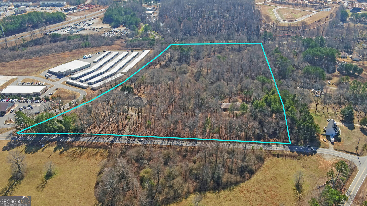 This +/- 20.89 acre tract is located just a 1/4 mile West of GA 400 in Dawsonville. Currently zoned RA (residential/AG), Dawson County has identified this parcel as GA 400 Mixed Use. Sewer is on site. Whitmire Rd W has a light at the intersection with GA 400 and this property also has easy access to Lumpkin Campground Rd. Property sits immediately West of a Self Storage Facility and a Car Dealership and immediately South of a large retail development including OneLife Fitness, Home Goods & Burlington to name a few.