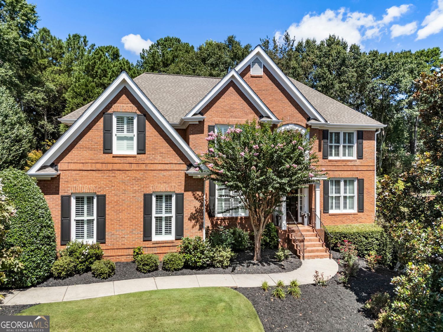 Welcome to the sought-after 'Lake Laurel' neighborhood in Milton - where quality, location, and style come together in one exceptional home. This beautifully maintained residence, constructed with classic brick and durable concrete siding, offers timeless curb appeal and thoughtful design throughout. Enjoy year-round outdoor living on the oversized screened porch, or retreat to the finished daylight terrace level - ideal for entertaining, a home gym, office, or guest accommodations. The inviting two-story great room features soaring cathedral ceilings, elegant crown molding, and fireplace, creating a warm and welcoming atmosphere. The updated kitchen features Quartz countertops, subway tile backsplash, double ovens, and a large center island - all seamlessly connected to the screened porch and private backyard. On the main level, you'll find a guest suite with full bath, a private office or sitting room, and a spacious dining room with lots of natural light. Upstairs, the expansive primary suite offers a spa-like bath with a soaking tub, upgraded cabinetry, and a generous walk-in closet. An en-suite secondary bedroom, plus two additional bedrooms and jack-n-jill bath - each with walk-in closets - provide comfort and convenience, all with easy access to the upstairs laundry room. The finished terrace level includes a large recreation area, full bath, office/flex room, and ample storage. Residents enjoy top-tier swim/tennis amenities and are minutes from award-winning public and private schools, upscale dining, Avalon, GA-400, Downtown Alpharetta, and the charm of Crabapple. This is a rare opportunity to own a meticulously cared-for home in one of Milton's most desirable communities - blending lifestyle, location, and luxury.