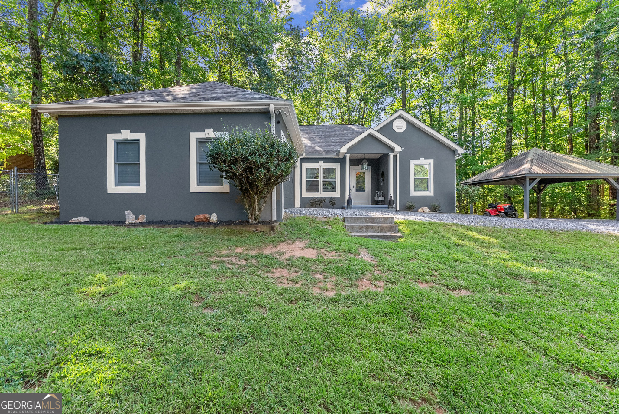 Great location, conveniently located between Cleveland and Helen, off of Helen Highway. With even better views! Nestled at the base of Mount Yonah, this charming 3 bed, 2 bath home offers seasonal mountain views and a tranquil setting. The open floor plan flows beautifully, and recent updates include a brand new primary bathroom (2025), exterior paint (2025), new AC unit (2023), roof (2021), fresh interior paint, new kitchen countertops, and an updated fireplace surround. Enjoy mornings on the spacious back deck overlooking the fenced yard, or take a quick 3-mile drive to the scenic town of Helen, GA. Additional covered parking included and Septic was emptied and inspected (2025).