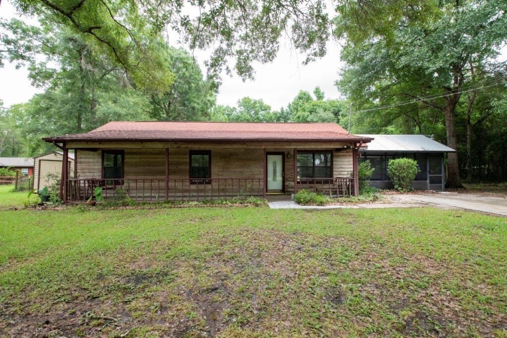 PLENTY OF ELBOW ROOM! THREE BEDROOM HOME SET ON OVER AN ACRE WITH NO CITY TAXES! THE EXTERIOR IS CONSTRUCTED OF WOOD SIDING AND FEATURES A SCREENED PORCH IN ADDITION TO A COVERED FRONT PORCH. RELAX ON THE PATIO INSIDE THE FENCED BACKYARD- STORAGE SHED IS INCLUDED! THE INTERIOR HAS BEEN FRESHLY PAINTED AND OFFERS PLENTY OF CABINETRY IN THE KITCHEN AS WELL AS INDOOR LAUNDRY. THE HALL BATH IS THE MAIN BATHROOM AND THE PRIMARY BEDROOM FEATURES A CONNECTED HALF BATH. THE VINYL WOOD FLOORS NEED TO BE REPLACED, BUT THIS PRICE INCLUDES A FLOORING ALLOWANCE OF $1,500 TO INSTALL CARPET THROUGHOUT THE FAMILY ROOM, HALLWAY, AND BEDROOMS. NO CITY WATER OR SEWER BILL! EASY TO SHOW OR SEE- MAKE YOUR APPOINTMENT TODAY!