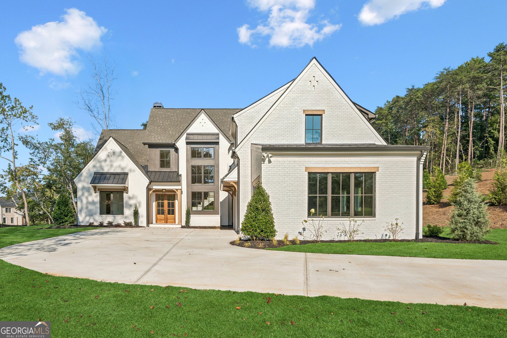 Pricing lowered by $250K for today's market! Up to $20,000 in Builder Incentives! Stunning custom-built home by J. Alan Custom Homes in the new gated community of Pilgrim Mill Farms. Prime location less than a mile to Tidwell Park on Lake Lanier and under 4 miles to GA 400, with top-rated schools, shopping, and dining nearby in the rapidly growing Cumming/North Forsyth area. This elegant home sits on ~ 2.056 acres and features 4 bedrooms, 4.5 bathrooms, a 3-car garage, and a refurbished barn. The open floor plan includes a main-level owner's suite, spacious scullery, mudroom, upstairs loft, secondary bedrooms, and optional bonus room. Enjoy outdoor living on the 12x42 covered porch with grilling area overlooking a level backyard with room for a pool. High-end finishes throughout deliver a sophisticated, luxury feel. Pilgrim Mill Farms is an exclusive enclave of five estate-size homesites, offering the perfect blend of privacy and convenience. Welcome home! ** Entrance to development is 4395 Pilgrim Mill Rd.