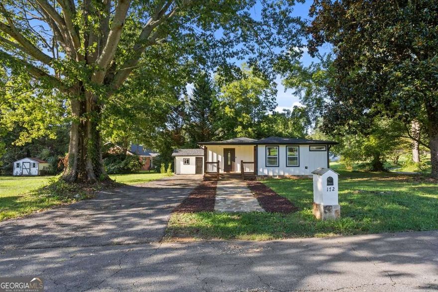 This stepless ranch is packed with modern upgrades and brand-new luxury vinyl plank flooring-all for under $300K! Perfectly positioned on a beautiful corner lot, this move-in ready home has everything you've been looking for, and even qualifies for USDA.    Step inside to an inviting open-concept layout highlighted by a farmhouse sink, soft-close cabinetry, upgraded outlets with USB ports, and a tankless water heater so you'll never wait for hot water again.    The oversized primary suite is filled with natural light and features a walk-in closet and a spa-like en-suite with dual vanities and a full-tiled shower. Secondary bedrooms are equally spacious-one with its own walk-in closet and barn door-and both have access to a beautifully upgraded hall bath with tile surround, glass sliding doors, and accessibility handrails.    Convenience continues with the centrally located laundry room and additional storage shed outside. Relax on the front or back porch, perfect for rocking chairs, grilling, or quiet evenings at home.    The location is convenient as well only 20 minutes to Waleska or Jasper and 15 minutes to Calhoun. Interstate 75 is just around the corner!    This thoughtfully built home truly has it all-modern finishes, functional upgrades, and plenty of charm. Don't wait-schedule your showing today!