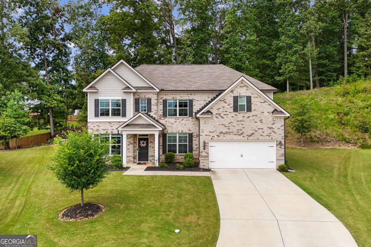 Welcome to 5065 Cooper Farm Drive, a stunning 4-bedroom, 3-bath home in the desirable Level Creek community of Buford. Built in 2021, this spacious residence offers over 3,200 sq ft of modern living with an open floorplan, 9' ceilings, and designer finishes throughout. The main level features a bright family room with fireplace that opens to the chef's kitchen, complete with granite countertops, oversized island, stainless steel appliances, white cabinetry, and a breakfast area overlooking the backyard. A private office provides the perfect work-from-home setup, while the main-level guest suite with full bath is ideal for visitors or multi-generational living.Upstairs, the oversized owner's suite offers a spa-style bath with dual vanities, soaking tub, walk-in shower, and generous closet space. Two additional bedrooms, a full bath, and a convenient upstairs laundry room complete the second level.Enjoy outdoor living on the covered patio overlooking the fenced backyard, perfect for gatherings or relaxation. Hardwood floors, neutral colors, and a 2-car garage add both style and convenience.Location is a true highlight-just minutes from Downtown Sugar Hill, Suwanee Town Center, Lake Lanier, and major highways (I-85 & I-985). Zoned to award-winning Lanier schools, this home offers both comfort and convenience in one of Gwinnett's most sought-after areas. Move-in ready and thoughtfully designed, 5065 Cooper Farm Drive is the perfect place to call home.