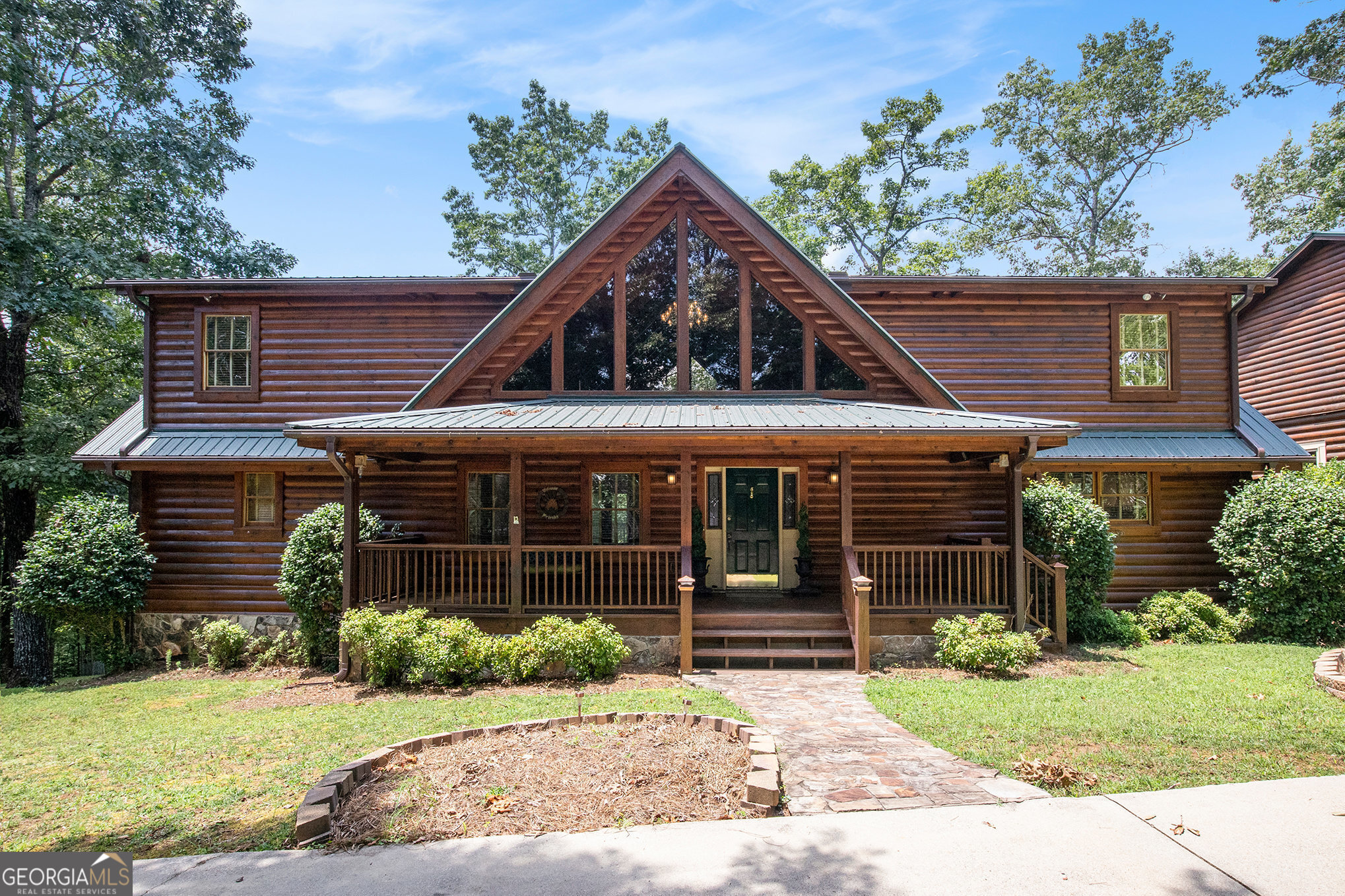 !!!A perfect opportunity for investors!!! This charming log cabin is an ideal income-producing Airbnb! Guests will love the breathtaking views, spacious layout perfect for large families, and the unbeatable convenience of being just minutes from downtown Dahlonega, Helen, and all that North Georgia has to offer. The mountains are calling-and this stunning log cabin retreat is your answer! This mountain-view home is filled with rustic charm and modern comfort, featuring dramatic windows that flood the space with natural light from both the front and back. Relax on the covered front porch overlooking a fenced-in garden-perfect for growing your favorite flowers or plants without worrying about deer. Step into the spacious open foyer, ideal for showcasing unique rustic furnishings. The great room welcomes you with exposed wood beams, a gorgeous rock fireplace that warms the entire space, and multiple French doors leading to the covered back deck-perfect for enjoying peaceful views of the mountain ridge, especially stunning during fall and winter. The open-concept dining area seats 12+ with room to spare for a large hutch and a statement deer antler chandelier imported from Wyoming. Just off the dining area, the kitchen features brand-new granite countertops, stainless steel appliances, and a cozy bay-window breakfast nook. The main-level and basement is handled by one separate HVAC system and the upstairs bedroom has its own separate system for year-round comfort. The owner's suite is a true retreat, complete with its own screened-in private patio. Upstairs, a bright and expansive loft offers mountain views and natural light from the oversized front window. Two generous bedrooms sit on opposite ends for privacy, each with its own en-suite bath. The finished lower level includes a bar with built-in cabinetry for your favorite spirits and glassware, a huge flex space ideal for a home office, and a private bedroom-perfect for guests or teens. Unwind in the sauna after a workout in your personal fitness room. There is wiring ready to go for a hot tub on the lower patio by the bedroom. There is a propane heater for an emergency backup. This will heat the entire basement. Storage is no issue here-this home has it all! The oversized 3-car garage has a fully finished upstairs suite with a full bathroom, offering endless possibilities. With a simple closet addition and a kitchenette in the larger room, it could easily be converted into a full 1-bedroom apartment-ideal for guests, a business setup, or income potential. And don't miss the basement under the garage, offering even more storage space for all your tools and making it your own workshop. You cannot get locked out for the garage as it has a battery backup on the garage door opener. You have a driveway to the back of the garage. Perfect place for an RV or your ATVs.