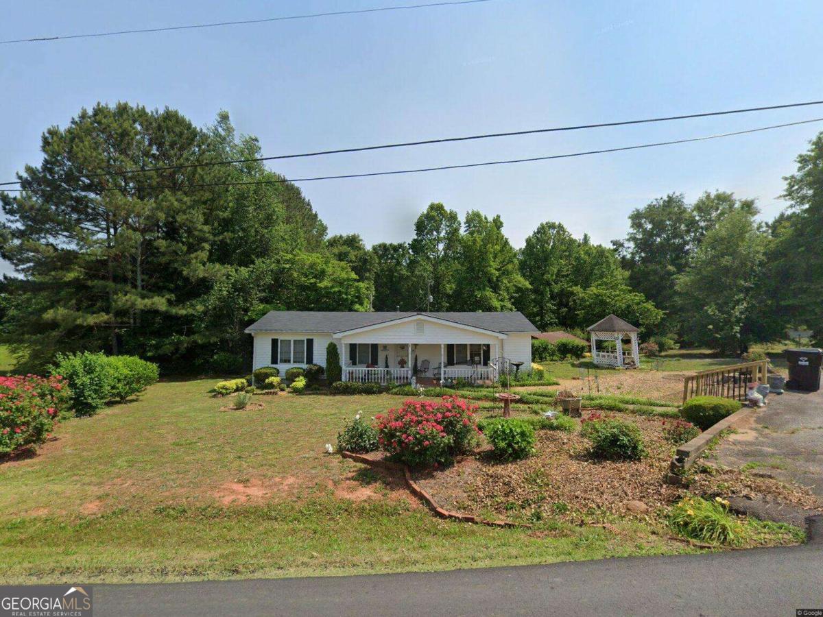 Great location with almost 2 acres. 3 bedroom 1 bath home with an additional home in the back of the property that is in need of repairs.