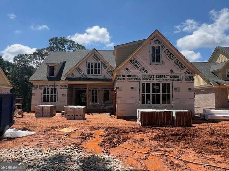 Home is Under Construction. The Charlotte plan by Tipton offers an outstanding living experience in the highly desirable Buford City School District. This 5 Bed/4.5 Bath home boasts quality craftsmanship, stylish finishes, and an open concept layout. Enter to 10' ceilings on main, a chef-inspired kitchen, complete with a large quartz island, walk-in pantry, upgraded stainless steel appliance package-all overlooking the open breakfast area and the expansive family room with built-in shelving and beams. Separate Dining Room/Flex Room. Additionally, complimenting the main level, mudroom & lockers off the garage next to the laundry room equipped with sink. Oversized Owner's suite on main includes relaxing spa-style bath with frameless glass shower, free standing soaking tub, quartz vanity and expansive walk-in closet. Spacious guest bedroom on main w/ attached ensuite and grand walk-in closet. Upper level leads to 3 generously sized bedrooms, 2 bathrooms, a media room, second level laundry room and additional storage space. The unfinished basement provides even more space for your personalized touches with unlimited potential. Large, covered deck with outdoor fireplace overlooks private back yard situated on .45 acre lot. Home is conveniently located near top rated Buford City Schools, easy access to downtown Buford dining, shopping, entertainment, parks, Lake Lanier and more!