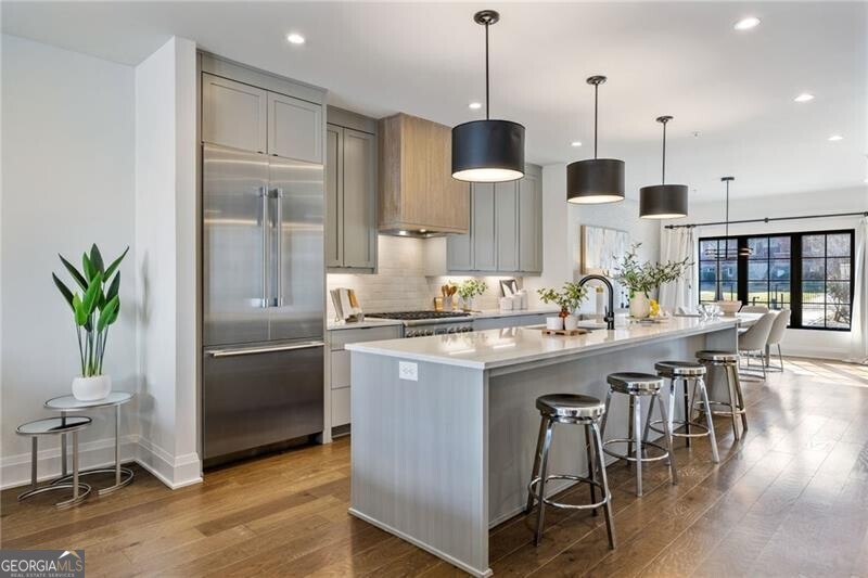 Fully furnished available! Nestled just steps from The Beltline & The Krog District, this expansive 4-bedroom, 4.5-bathroom residence offers the ideal Intown living experience, featuring generous space & an exceptional layout. As the largest floor plan in the community, it has been designed to enhance privacy and maximize natural light in every room. Featuring a two-car garage, rooftop deck, and private elevator access to all floors for ultimate convenience. The main level showcases an open-concept design, complete with dedicated dining and a chef's kitchen equipped with an oversized island, bar seating, Thermador appliances, & a wine fridge. The adjoining living area is spacious and inviting, with built-in shelving flanking the fireplace. Upstairs, the primary suite offers dual walk-in closets, dual vanities, and oversized shower, while the second guest bedroom includes an en-suite bathroom. Accessed via the private elevator, the fourth-floor entertainment space provides a versatile secondary living area or flex space, along with a third bedroom and en-suite bath. The expansive rooftop deck is perfect for alfresco dining and features an additional seating area with skyline views. The terrace level includes a private entry, fourth bedroom with an en-suite bathroom, and the two-car garage, completing this Intown gem. With the Beltline just moments away, Krog St Market nearby, and Inman Park within walking distance, this property offers unparalleled access to the best of Intown living. Don't miss the opportunity to experience the perfect combination of quality, location, and lifestyle.