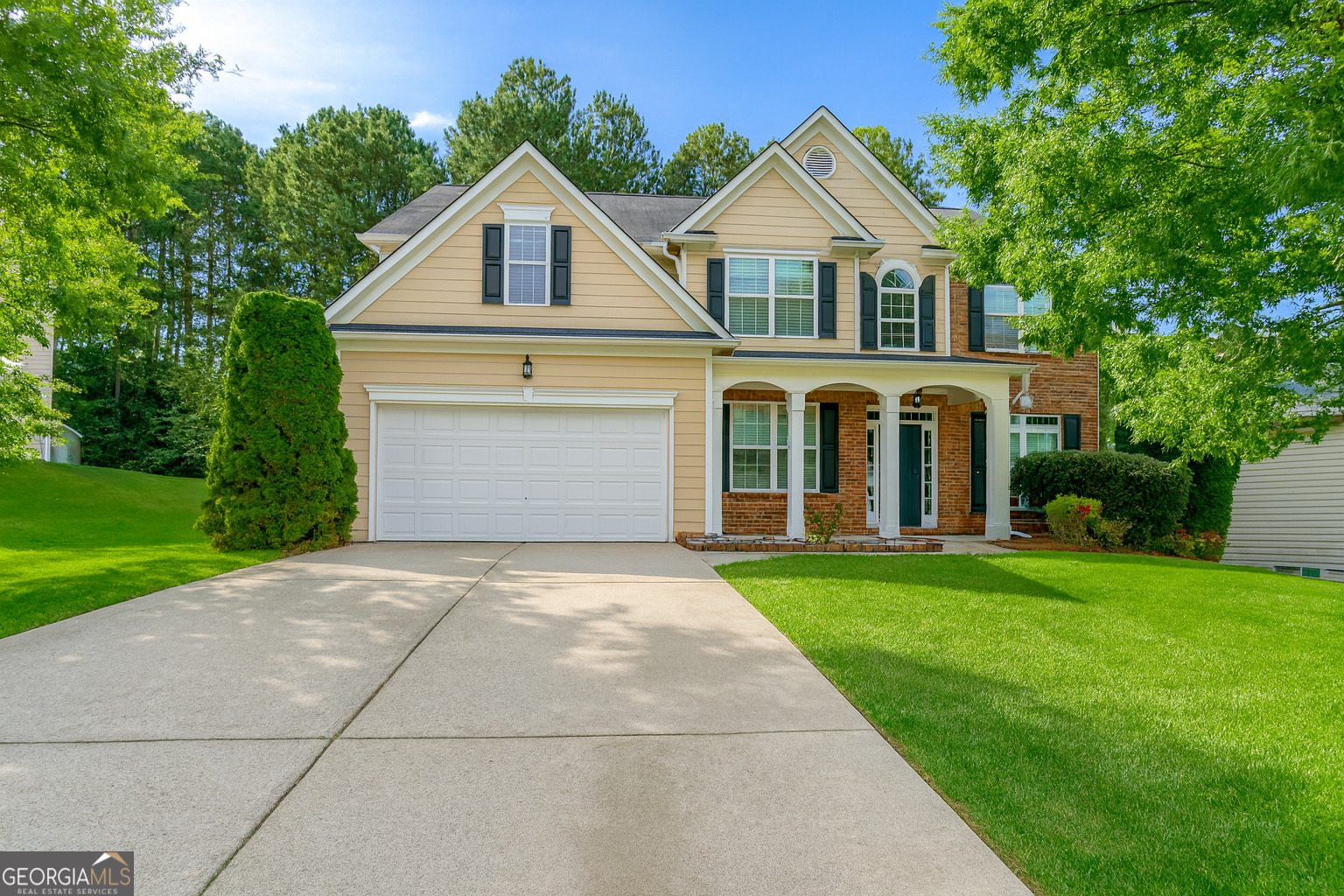 Meticulously Maintained & Move-In Ready! This spacious 5 bedroom, 4 full bathroom home offers a soaring two-story living room and foyer that fill the space with natural light, creating a bright and welcoming atmosphere. The main level features a large bedroom with a full bath, perfect for guests or a home office. Freshly painted interiors and a charming front porch make this home warm and inviting. The separate living and dining rooms provide plenty of room for entertaining, and the wooded backyard offers privacy and outdoor enjoyment. Located in the highly sought-after Archer High School district, just minutes from shops and dining, and nestled in a swim and tennis community - this home truly has it all. Qualifies for 100% financing!