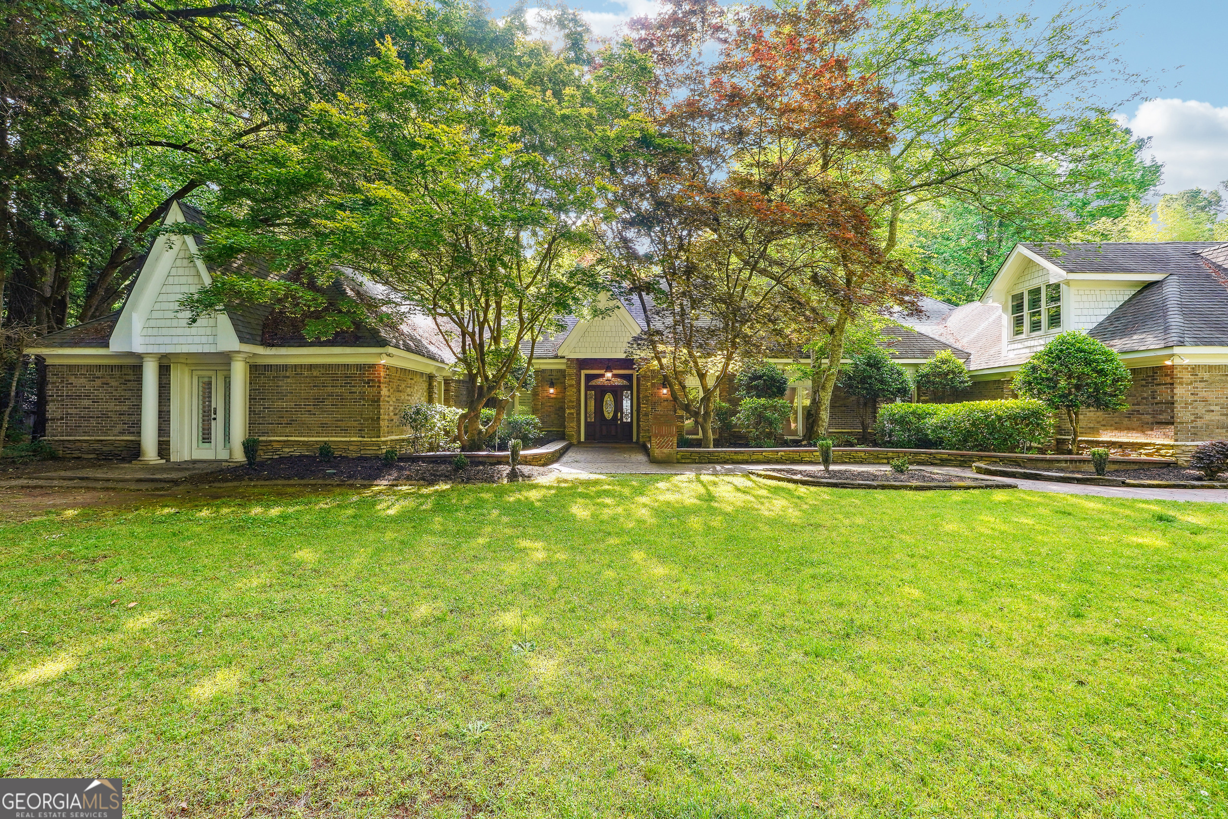 Welcome to 13039 Freemanville Road! This luxury 9 bedroom and 10.5 bathroom home is located in Alpharetta, Georgia. Drive into the gated entrance into this beautifully landscaped estate. This home is nothing short of exquisite with craftsmanship and custom details: a Stunning foyer, 12+ dining room, a gourmet kitchen featuring quartz countertops and gold kitchen fixtures and stainless appliances, custom cabinets, walk-in pantry and large keeping room with fireplace which opens to the courtyard. The main level features 3 bedrooms /3.5 baths including a massive owner's suite with sitting area, trey ceilings and spacious custom closet. Head upstairs using the front & rear staircases~the upper level features 3 ensuite bedrooms, 4 full bathrooms and a very generously sized Junior Owner's Ensuite. Take a breath in the beautiful courtyard and enjoy the fountain or the outdoor brick pizza oven. The guest house holds a beautiful 2 story foyer, full kitchen 2 bedrooms/2 bathrooms and laundry room. The pool house has room for a full bar, additional office space, or a content area. This home is immaculate and very well maintained with so many custom touches throughout including 3 fireplaces, an infrared sauna, steam room, massage parlor, 5 car garage with tons of storage. Seller is open to owner financing with flexible terms for qualified buyers. Great opportunity for buyers seeking alternative financing options.