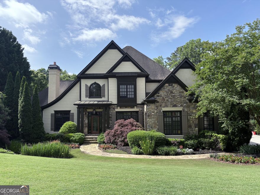 This luxurious estate home is a true showstopper perfectly positioned on a private lot with breathtaking views of Sope Creek. Nestled on a serene 1-acre lot overlooking the winding rivers, this exceptional property is designed for both grand entertaining and peaceful retreat. Boasting two stunning pools and a full turf backyard  perfect for summer gatherings and twilight soirees the home seamlessly blends outdoor beauty with refined interiors. The Master suite on the main level offers comfort and convenience, with a tranquil sitting room overlooking a private water feature. The large Sunroom with panoramic views adds a serene touch of charm. A fully finished basement expands the living space to accommodate friends and family with a golf simulation room, a home gym, and an additional guest suite. With elegant finishes, generous square footage, and unmatched natural surroundings, this home is a rare blend of sophistication, serenity, and fun all wrapped into one remarkable estate.