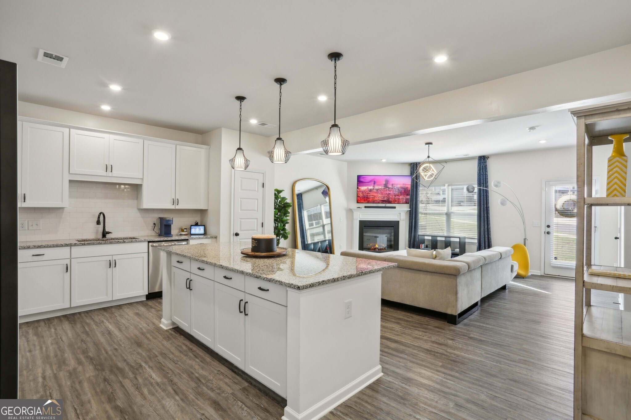 Welcome to this Immaculate End Unit Townhome in the Sought-After Concord Community, right in the Heart of Woodstock! Tucked perfectly between Downtown Woodstock, Roswell, and Milton, this home offers Prime Location with everyday Convenience. Step inside and you'll be greeted by tons of Natural Light pouring through Large Windows, highlighting the Open Concept Living Area with Gorgeous Hardwood Floors and Stylish Finishes throughout, perfect for a relaxing night or entertaining guests. The Eat-In Kitchen is a true Showstopper - complete with a Large Island, Stainless Steel Appliances, Quartz Countertops, White Cabinets, and Tons of Storage. A thoughtfully placed Powder Room finishes off the main level. Upstairs, the Primary Suite is the perfect Retreat. Enjoy a Spacious Bedroom, a Spa-Like Ensuite Bathroom with a Soaking Tub, Separate Walk-In Shower, Dual Vanities, and a Huge Walk-In Closet. Two Additional Bedrooms offer Flexibility for a Home Office, Guest Room, or Family Space, and they share a Full Bath. The Two-Car Garage provides Extra Storage and Shelter for Your Cars Year-Round. Neighborhood Perks like Sidewalks, Street Lights, and Dog Stations give it that Welcoming, Community Feel. Just minutes from Shops, Grocery Stores, Entertainment, and Top Schools - this home checks all the boxes for Comfort, Style, and Location. Don't miss your chance to live in a space that's more than just a home - it's a Lifestyle.