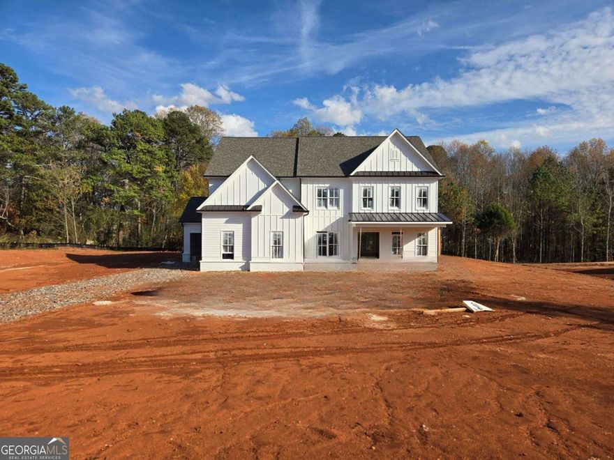 The Avondale Plan by Tipton Home Builders - This stunning open-concept Craftsman-style home offering 5 bedrooms, 4 bathrooms, with a 3-car garage, all situated on a spacious 1.70-acre lot with no HOA!!! From the welcoming covered front porch, step into an impressive two-story foyer that sets the tone for the elegant design throughout. The main level features soaring 10-foot ceilings (9' on the upper level) and an ideal layout for both everyday living and entertaining. A private study sits opposite the formal dining room, which connects through a butler's pantry to the gourmet chef's kitchen. This kitchen is a showstopper, featuring a large eat-in island, ceiling-height cabinetry, quartz countertops, and stainless-steel appliances, including a double oven.  The kitchen opens to a bright breakfast area, a keeping room, and a family room featuring custom-built-ins and a designer fireplace. Step outside to the extended covered rear porch, complete with a brick fireplace - perfect for year-round entertaining, dining, and relaxation.  Additionally, the main level features a guest bedroom, a full bathroom, and a mudroom with built-in lockers, all conveniently located off the garage.  Upstairs, you'll find an expansive primary suite with a spa-inspired bath, including a soaking tub, tiled glass shower, dual quartz vanities, and a large walk-in closet. Three additional bedrooms and two full bathrooms complete the upper level, along with a generous media room offering versatile space for a playroom, home theater, or gym. Ideally located with easy access to Hwy 400, shopping, dining, and entertainment, this home offers the perfect blend of luxury, comfort, and convenience. Home is under construction - please use caution when visiting.