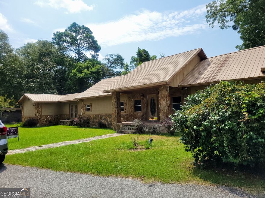 NESTLED in the heart of Tifton, this 4 bedroom and 2 bath home is conveniently located to: schools, shopping, parks, and entertainment.  With approx. 2747 sq ft, this home includes a spacious kitchen with ample cabinets.  The master suite is a private retreat, located at one end of the house, and boasts a luxurious double vanity, a relaxing whirlpool bathtub, and spacious walk-in closets. Enjoy multiple living spaces with a separate den, living room, and dining area, perfect for both entertaining and everyday living. The home also includes a dedicated laundry room for added convenience. Outside, you'll find a 2-car carport providing ample parking. This home offers the perfect blend of comfort and privacy. Don't miss out on this incredible opportunity! Motivated Seller! Call your Realtor today.
