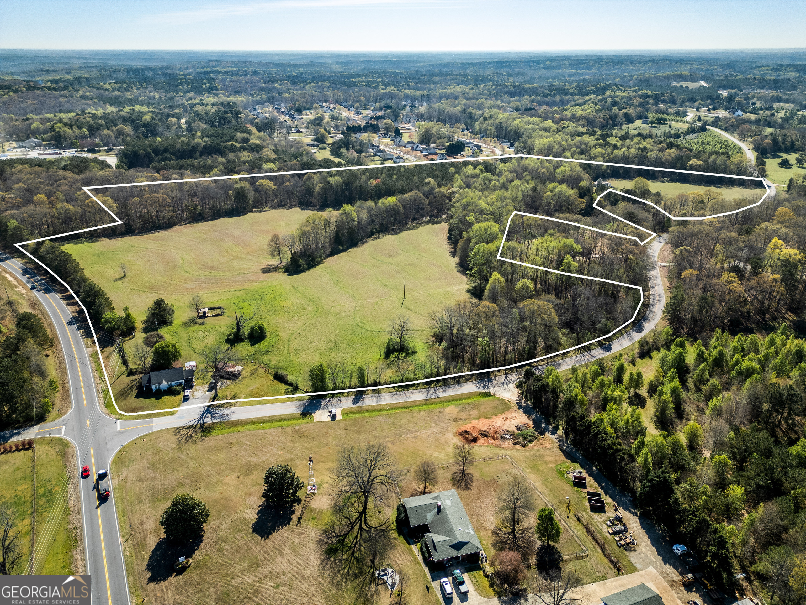 This 43.85-acre tract in Henry County is a fantastic opportunity for residential development. Located at the corner of Hwy 138 and White Drive, the property offers great visibility and access to major roads. The land includes an older 2-bed, 1-bath home (approximately 1,000 sqft) perfect for renovation or as temporary living quarters. Additionally, there is a barn located toward the back of the property with a 53' shipping container for storage. Utilities are in place with gas, water, and electric already run to the property, though there is no sewage. The large lot provides ample space for development, making it an ideal location for your next residential project. Call or email for showings (appointments only) sales@primepointventures.net or 478-394-4545.