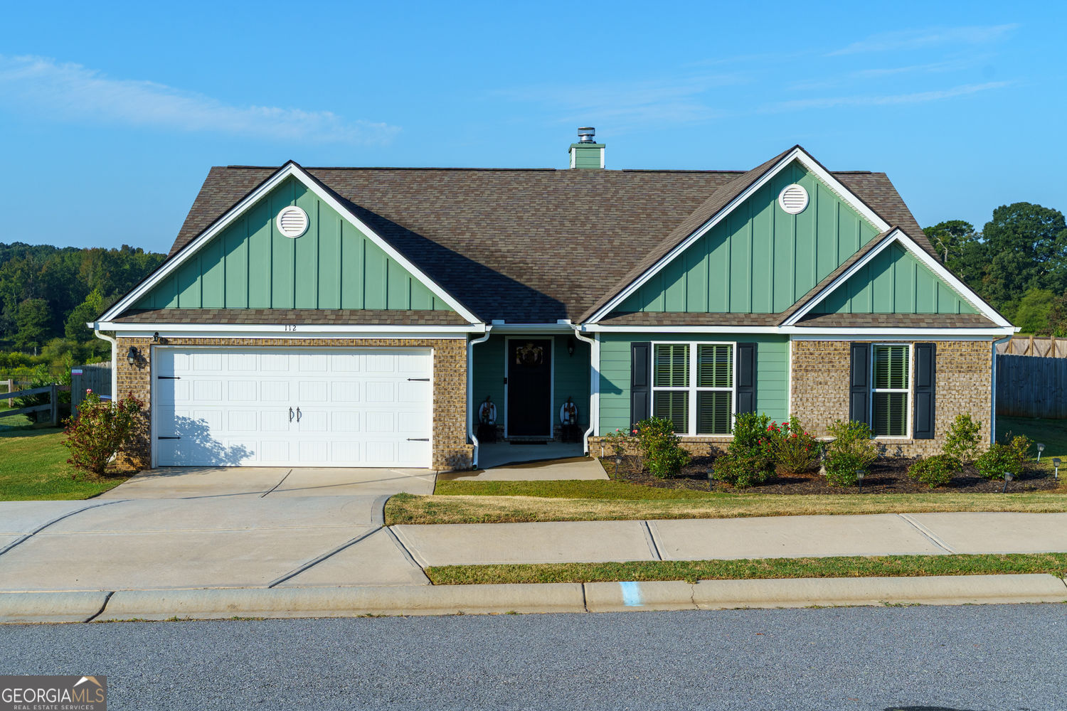 One-owner, impeccably maintained ranch on over a half-acre fenced lot in Winder's Barrow County. This open-concept home showcases rich wood floors, vaulted ceilings and a brick fireplace. The chef's kitchen offers white cabinetry, granite counters, stainless appliances and a large island, flowing to both a formal dining room with wainscoting and a sunny breakfast area. The private owner's suite features a tray ceiling, double vanity and walk-in closet. Three additional bedrooms provide flexible space for family, guests or a home office. Relax on the covered back porch and extended deck overlooking the expansive, level yard-ideal for play, gardening or a future pool. Convenient to downtown Winder, Athens and I-85 for easy Atlanta access, 112 Shallow Way delivers space, style and true move-in readiness.