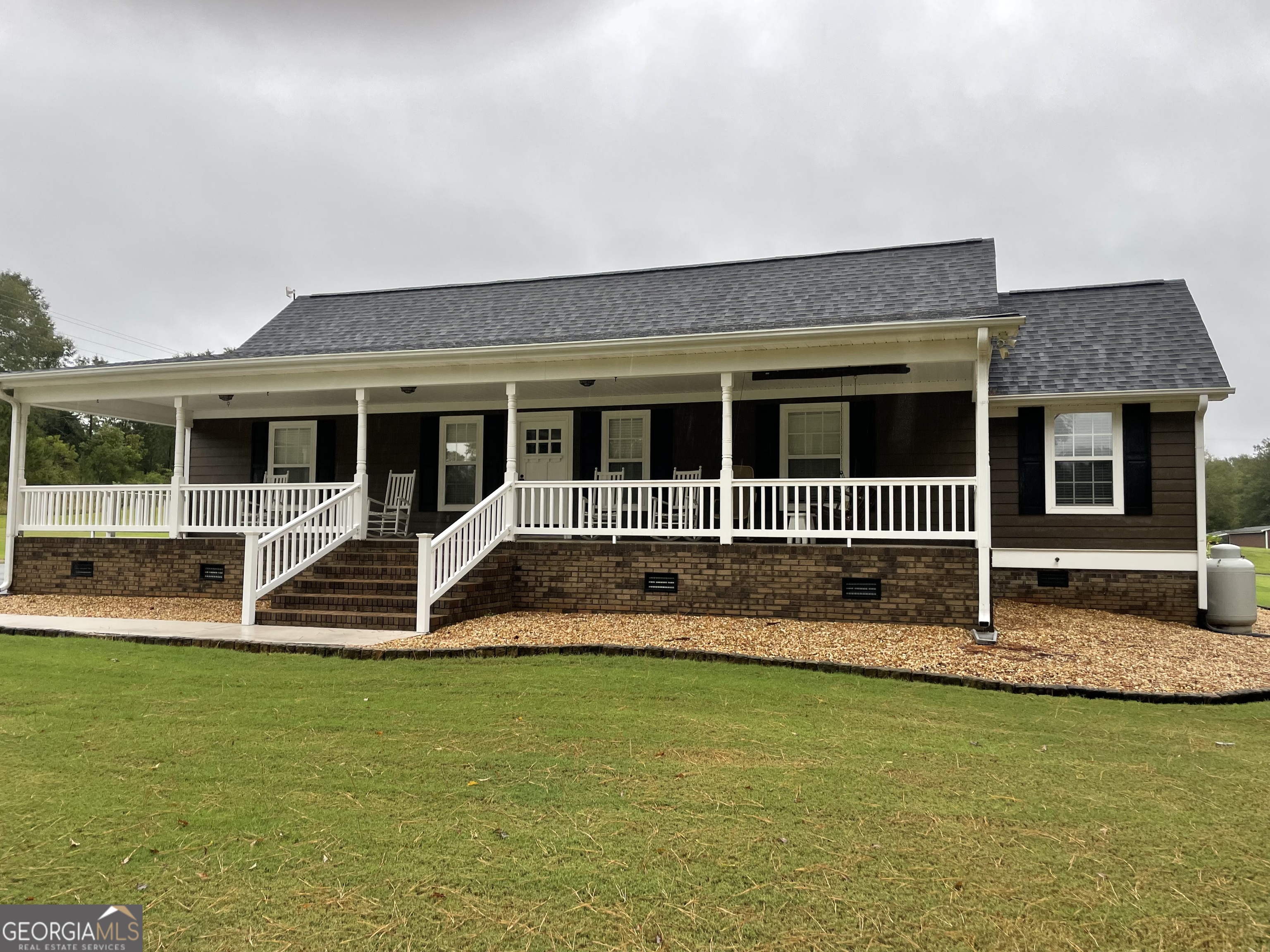 Welcome to this immaculate Farm on 7.97 acres in Beautiful Lamar County Ga. This absolutely stunning property features a home with three bedrooms and two bathrooms (1312 sq ft). Home features crown molding throughout, Laminate flooring throughout, solid wood doors, Quarts and granite countertops, Stainless steel appliances, touch kitchen faucet and a tankless hot water heater. Home also features a beautiful 12' x48' front porch with swing (vinyl post and railings) and two rear patios (30x16 and 24x16) all for your outdoor enjoyment. Home has approx. 480' attic storage. Property features include: 16'x48' Carport with metal roof and concrete floor. 24'x48' wood/workshop with concrete floor, fully insulated with heat and air, Full bath, some wood working equipment, and approx. 450 sq ft attic storage. 12'x22' lean-to off the back of wood/workshop with concrete floor 30'x40' Barn with metal roofing and siding, 8'x10' feed and tack room with concrete floor, Metal sliding doors on front and rear entrances, 7 individual stalls, and water in main alleyway. 36'x60' Red iron steel; engineered building, Completely insulated, with 6" concrete floor with rebar and a 40' long overhead rail crane system. Building includes a 15'x20' Full kitchen with mini split HVAC electric refrigerator, gas stove, and an abundance of cabinets and shelving. Rear of building has a 12'x24' porch with metal roof and concrete floor, and a swing. 36'x60' Red iron steel, engineered building with one exterior wall 60' long with 6" concrete floor with rebar and metal roofing. 12'x40' Masonry/steel barn with metal roof, concrete floor and electrical service. 12'x70' Masonry/steel barn with metal roof and concrete floor. 2 separate 16'x20' 3 sided, concrete and wood structures with metal roofing. Other property features include Irrigation system with 42 heads covering approx. 1 acre, 7 frost proof water faucets throughout property. At the rear of property 2800' of fencing creates 7 different grazing paddocks. 350' pf asphalted driveway with parking area, driveway alarm, playground for children or pets, 6' stainless steel fire pit, and a unique Tractor Mailbox. So if you are looking for a beautiful small farm that is ready for anything you can throw at it This is it.
