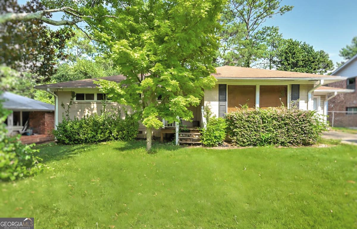 ** WORRIED ABOUT MONTHLY PAYMENT? My preferred lender is **working miracles** SAVING CLIENTS THOUSANDS of dollars per year! ** Ask about DOWN PAYMENT ASSISTANCE available to qualified homebuyers through Preferred Lender! Welcome to 2735 Spring Dr SE-an unbeatable opportunity in prime Smyrna just minutes from Truist Park, The Battery, and I-75/I-285! This charming 3-bedroom, 2-bath ranch sits on a flat, private lot in a quiet, established neighborhood. Inside, you'll find a spacious layout with real hardwood floors, an open living and dining area, and a granite kitchen ready for your personal touch. The primary suite features an ensuite bath, while two secondary bedrooms share a full hall bath. Step outside to enjoy a large, fenced backyard and enclosed patio with fireplace-perfect for relaxing or entertaining. Walk to nearby schools, shops, parks, and restaurants. Whether you're a first-time buyer, investor, or looking to renovate and build equity, this location checks all the boxes! IMAGES VIRTUALLY STAGED. PRICED TO SELL AS IT NEEDS SOME TLC. MOTIVATED SELLER. ALL REASONABLE OFFERS CONSIDERED.
