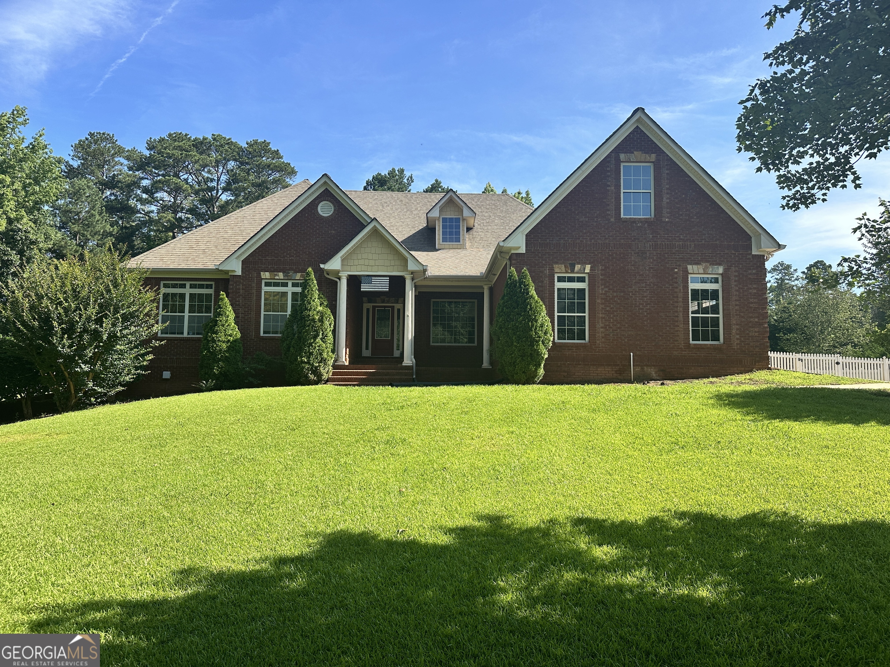 Beautiful brick home in Newton County. Master on main with trey ceilings, Master bath with spa tub, separate shower, separate vanities and walk in closet. Kitchen w/granite counter tops, custom kitchen cabinets, island containing sink, dishwasher, separate cook top and wall oven, breakfast area and walk in pantry. Kitchen opens to family room w/fireplace. Separate dining room. Hardwood floors throughout main living area. Upper-level suite with living room, bedroom, and full bath. Full unfinished basement with 95% of HVAC installed and Partial Bath. The septic is permitted for 1 bedroom/1 bath to be finished in the basement. We have a quote from contractor to finish basement and will share with a potential buyer. Covered deck off rear. Enclosed side yard with white picket fence. Main interior of the home has freshly painted walls and trim. Irrigation system.