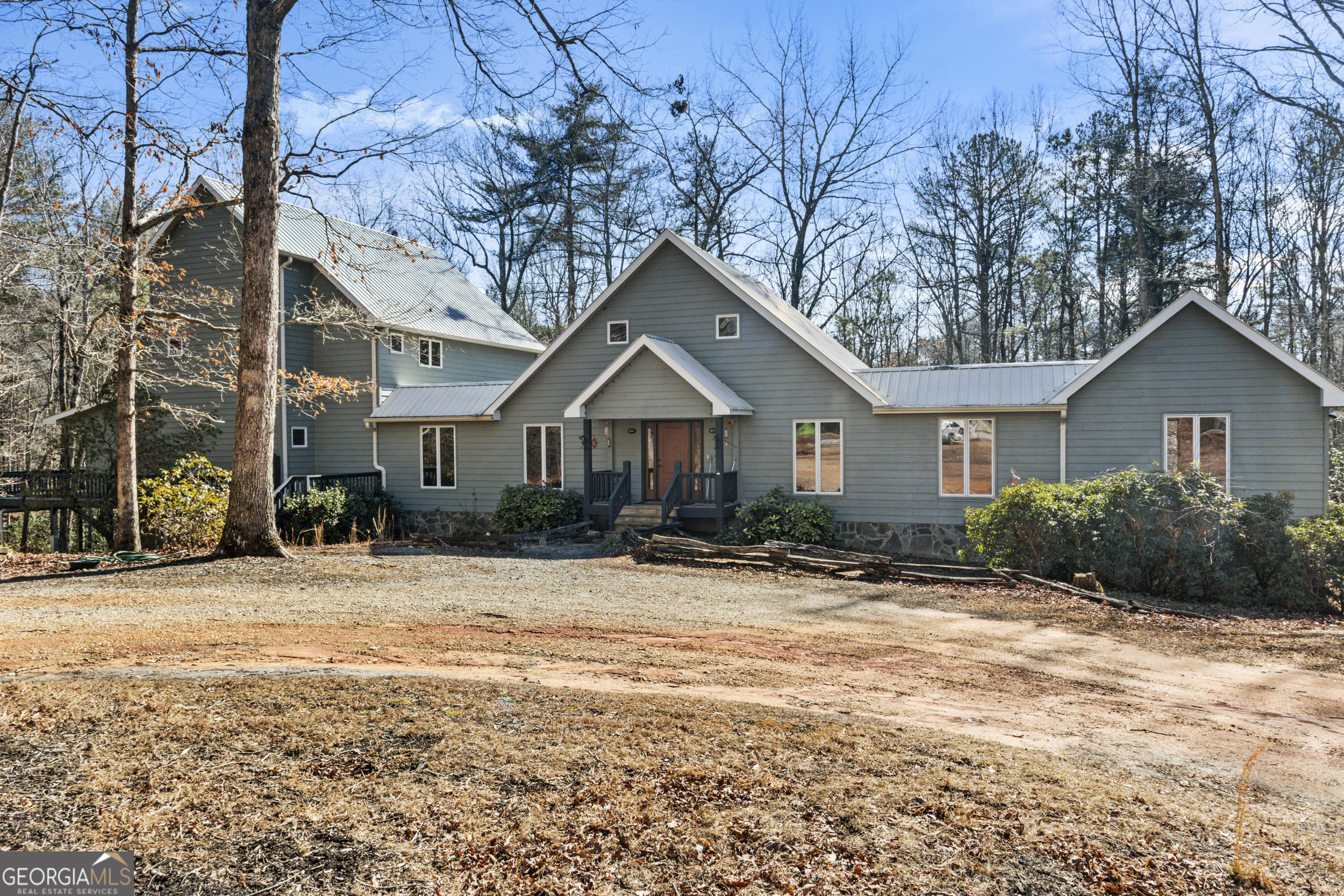 Looking for that EXCEPTIONAL, ONE-OF-A-KIND HOME? Then this custom-built, spacious, lovely home north of Clarkesville is for you!! It boasts over 3,000' of main-level living -- including the large master suite. The first (of 2) kitchen/dining areas is roomy with great views of the property to enjoy. The three oversized bedrooms all have their own ensuite bathrooms and are separated to give great privacy to each unit. Additionally, there is also a separate wing with a private bedroom, bathroom and full second kitchen. The extra wide hallway was originally built to show off the owner's collection of paintings. This home was thoughtfully designed for two-family or multi-generational living and it shows up in very appealing touches. The property boasts 4.3 acres enhanced with a rushing stream that joins the National Forest near Lake Burton, Glenn Ella Springs and all the natural beauty that goes with it. And we're not through! How about your own private, detached super-modern office with an attached, large shop. Want even more? How about a fenced-in dog lot with an insulated, custom dog house. We're still going -- there is a great garden spot as well as plenty of gentle land for other outside activities. And there is also a covered shed with enclosed storage for garden tools, etc. Can I bring up flexibility? This home could be easily converted into 3 separate living/sleeping areas. Mother-in-law, teenagers, roommate situation, or overnight rentals might all be possibilities. Downstairs, you'll find a large basement that is already being used for great storage and could be easily finished out for more heated living space. Home is triple zoned -- upper, main, and basement levels are all the same temperature. Ductwork has blue lighting to help control allergens. This home is sure to not disappoint! Give me a call today to set up an appointment.