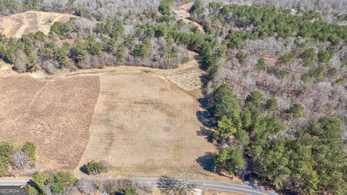 Nestled in the highly sought-after area of Loganville, GA, Lot 3 offers a sprawling 20-acre retreat on the picturesque Kent Rock Rd. With nearly 1,000 feet of prime road frontage and county water access at the street, this property boasts convenience and charm. The front features a generous four-acre clearing, ideal for building your dream home surrounded by natural beauty. Its strategic location provides swift access to Highway 138 and Highway 78. The property is just a short ten-minute drive from downtown Loganville and a fifteen-minute drive to Monroe. This versatile parcel allows for future subdivision into smaller lots, making it perfect for developing a family compound or investment opportunity. Enjoy the proximity to numerous amenities: a mere three miles to the nearest hospital, minutes from the vibrant communities of Loganville and Grayson, and a twenty-mile drive to the breathtaking sights of Stone Mountain and twenty-minutes from Arabia Mountain. Adventure and tranquility await offering a unique escape into nature. Seize the opportunity to create your vision on this unparalleled piece of land.
